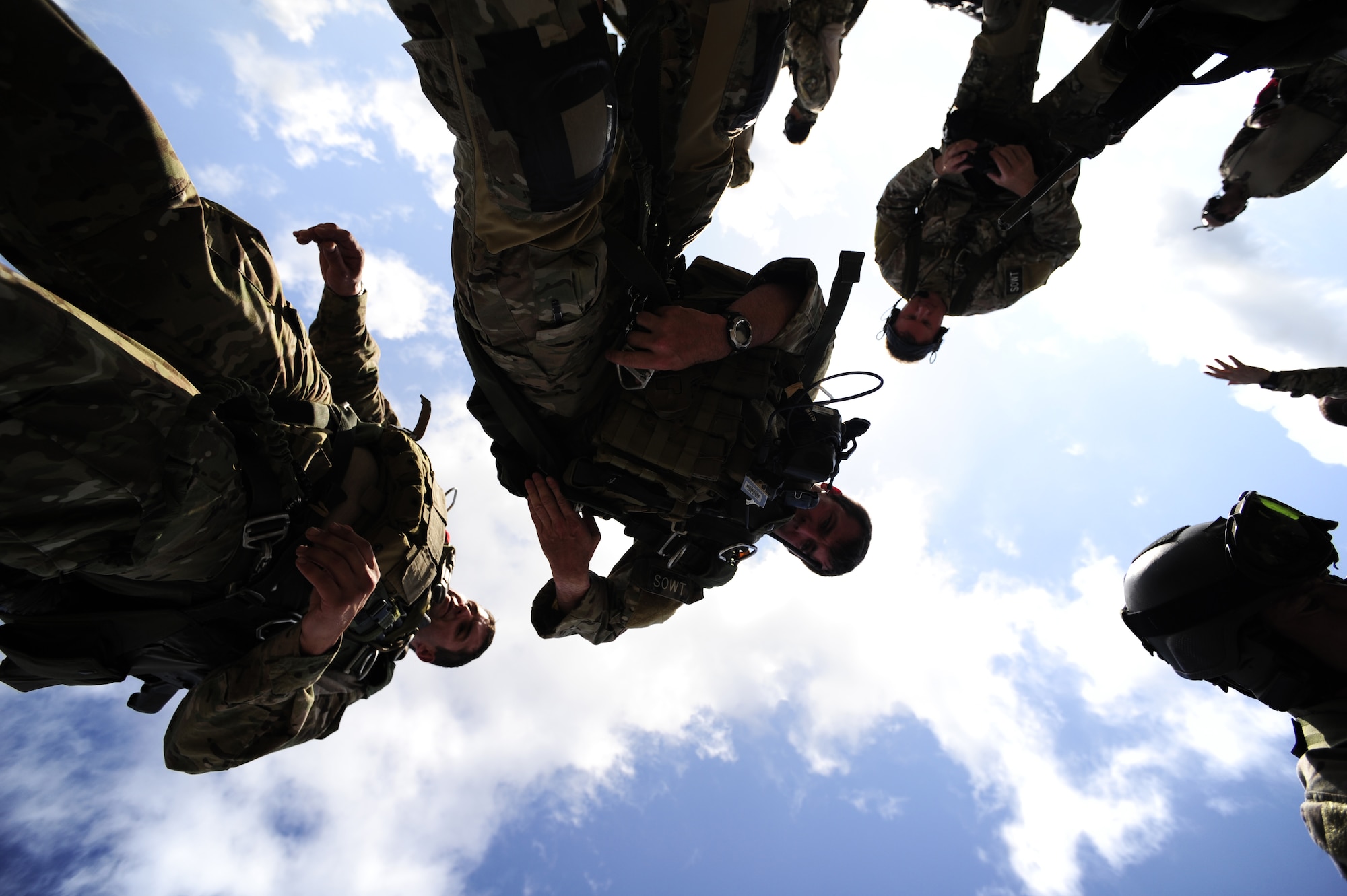 A Special Operations Weather Team from the 10th Combat Weather Squadron, dons parachutes before boarding a 9th Special Operations Squadron MC-130P for Operation Nimble Response, Hurlburt Field, Fla., May 11, 2011. Operation Nimble Response is an exercise to hone humanitarian and disaster relief efforts. Close to 50 personnel from Head Quarters Air Force Special Operations Command, 1st Special Operations Wing, and 280th Combat Communications Squadron, in coordination with USAID, worked together to improve disaster response. (U.S. Air Force photo by Staff Sgt. Julianne M. Showalter/Released)