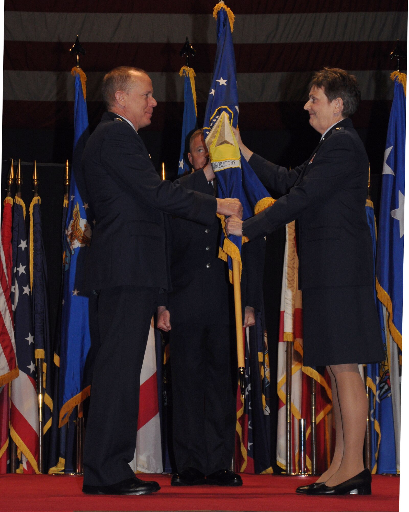 Gen. Donald J. Hoffman, commander, Air Force Materiel Command, retrieves the Air Force Research Laboratory guide-on from Maj. Gen. Ellen Pawlikowski, departing AFRL commander, at a change of command ceremony held Friday, May 13, at the National Museum of the United States Air Force. Maj. Gen. William McCasland will succeed General Pawlikowski, who was confirmed for appointment to the grade of lieutenant general with assignment as commander, Space and Missile Systems Center, Air Force Space Command, Los Angeles Air Force Base, Calif. (U.S. Air Force photo)