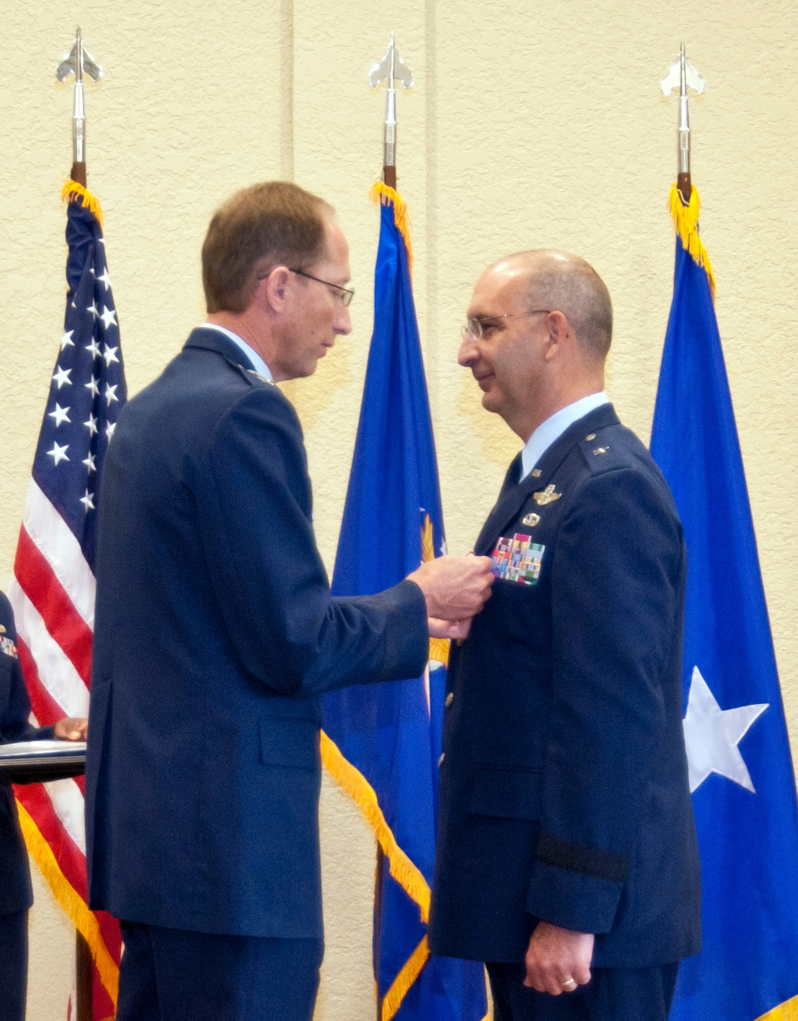 General Rubeor pins the Legion of Merit medal on General Muscatell during the 403rd Wing change of command ceremony May 12 at the Bay Breeze Event Center.  This is his second oak leaf cluster for the medal. (U.S. Air Force photo by Tech. Sgt. Tanya King)