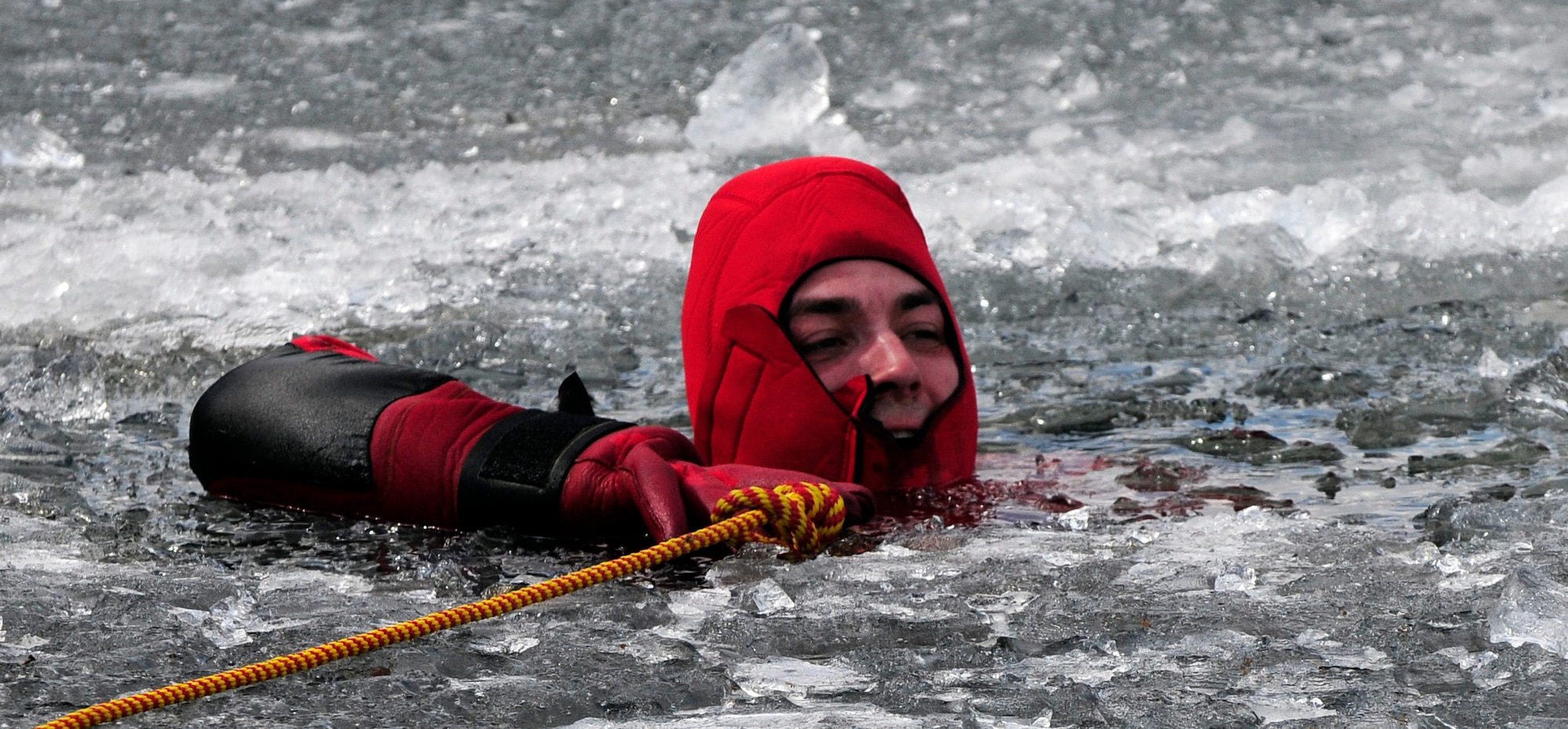 Airman 1st Class David Piasecki volunteers to be a victim in an icy lake during ice water rescue training May 6, 2011, Eielson Air Force Base, Alaska.  Emergency rescue Airmen train to stay prepared in the event of an emergency since Alaska lakes are frozen nine to 10 months of the year. Airman Piasecki is assigned to the 354th Civil Engineer Squadron Fire Protection Flight. (U.S. Air Force photo/Airman 1st Class Laura Goodgame)