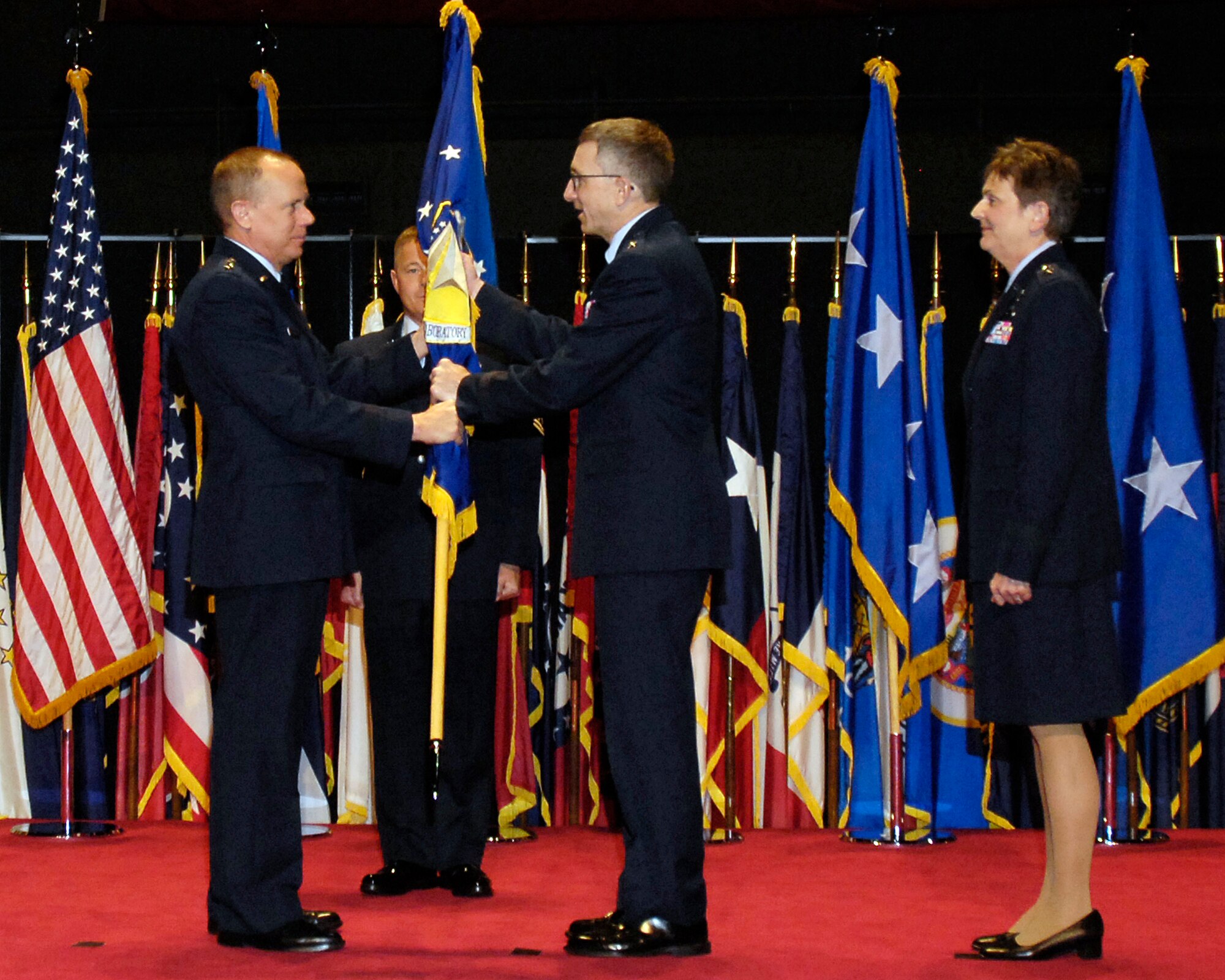 Gen. Donald J. Hoffman, commander, Air Force Materiel Command, presents the Air Force Research Laboratory guide-on to Maj. Gen. William McCasland, newly selected AFRL commander, at a change of command ceremony held Friday, May 13, at the National Museum of the United States Air Force.  Maj. Gen. William McCasland will succeed General Pawlikowski, who was confirmed for appointment to the grade of lieutenant general with assignment as commander, Space and Missile Systems Center, Air Force Space Command, Los Angeles Air Force Base, Calif. (U.S. Air Force photo)