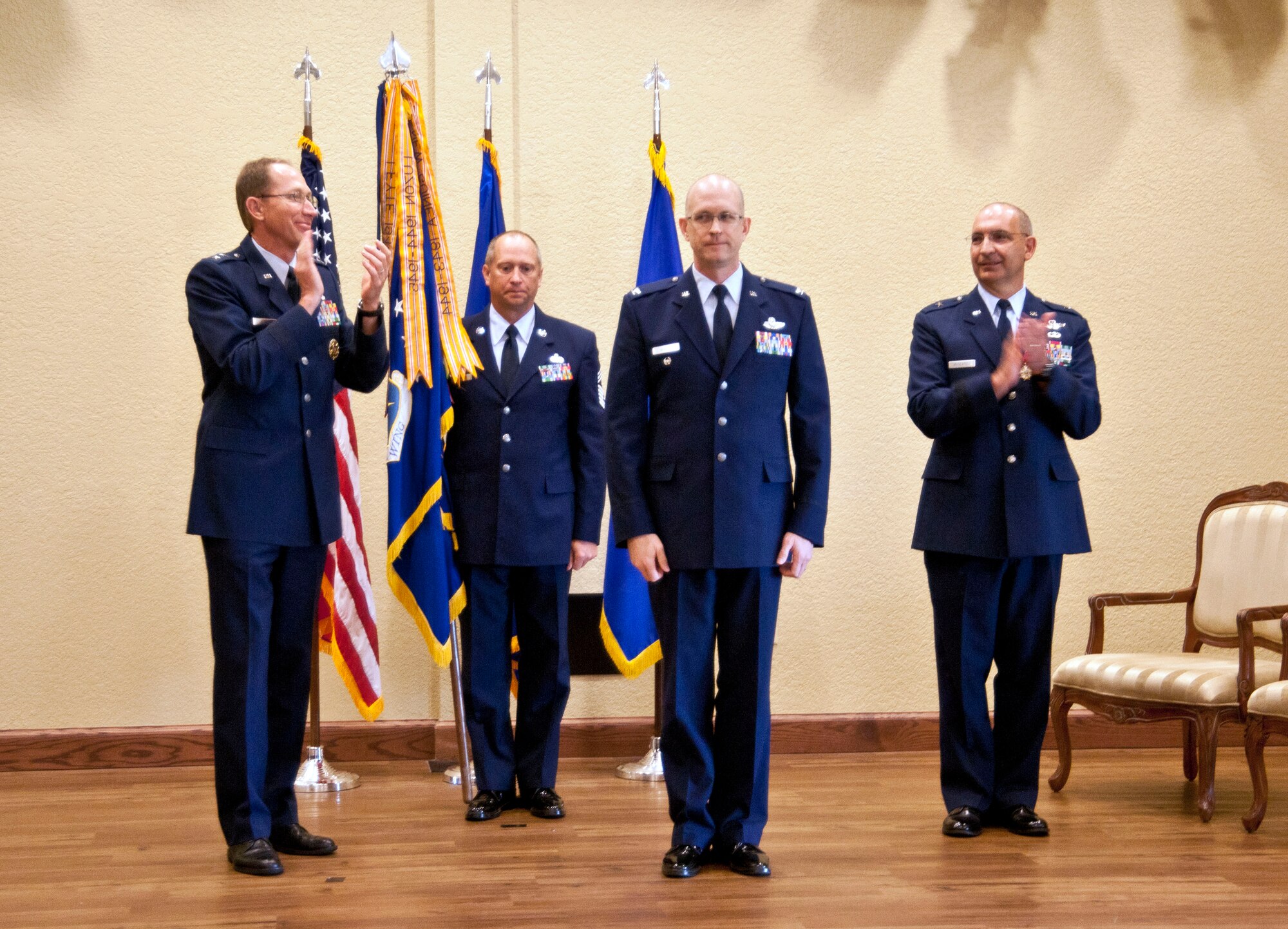 Generals Rubeor and Muscatell lead the audience in a round of applause as a Colonel Jensen is officially named 403rd Wing commander in a change of command ceremony May 12 at the Bay Breeze Event Center.  (U.S. Air Force photo by Tech. Sgt. Tanya King)