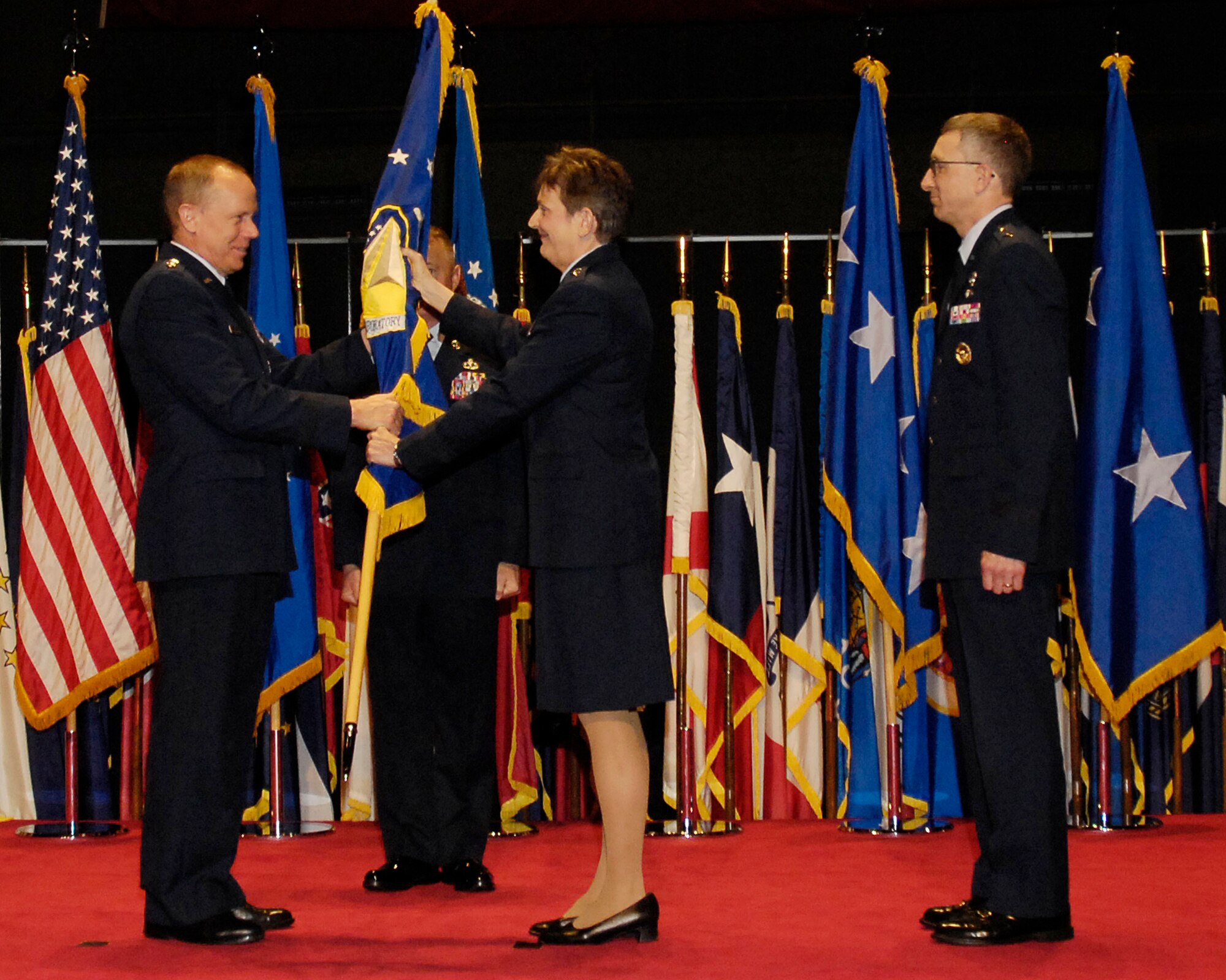 Gen. Donald J. Hoffman, commander, Air Force Materiel Command, retrieves the Air Force Research Laboratory guide-on from Maj. Gen. Ellen Pawlikowski, departing AFRL commander, at a change of command ceremony held Friday, May 13, at the National Museum of the United States Air Force. Maj. Gen. William McCasland will succeed General Pawlikowski, who was confirmed for appointment to the grade of lieutenant general with assignment as commander, Space and Missile Systems Center, Air Force Space Command, Los Angeles Air Force Base, Calif. (U.S. Air Force photo) 