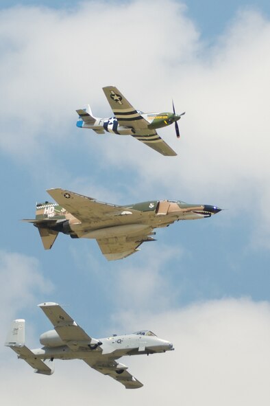 A P-51 Mustang, an F-4 Phantom and an A-10 Thunderbolt II fly together in a Heritage Flight over the 2011 Defenders of Liberty Air Show at Barksdale Air Force Base, La., May 7-8. Heritage Flights offer attendees a rare opportunity to see historic and modern aircraft in formation together. (courtesy photo by Mr. Chris Reich)