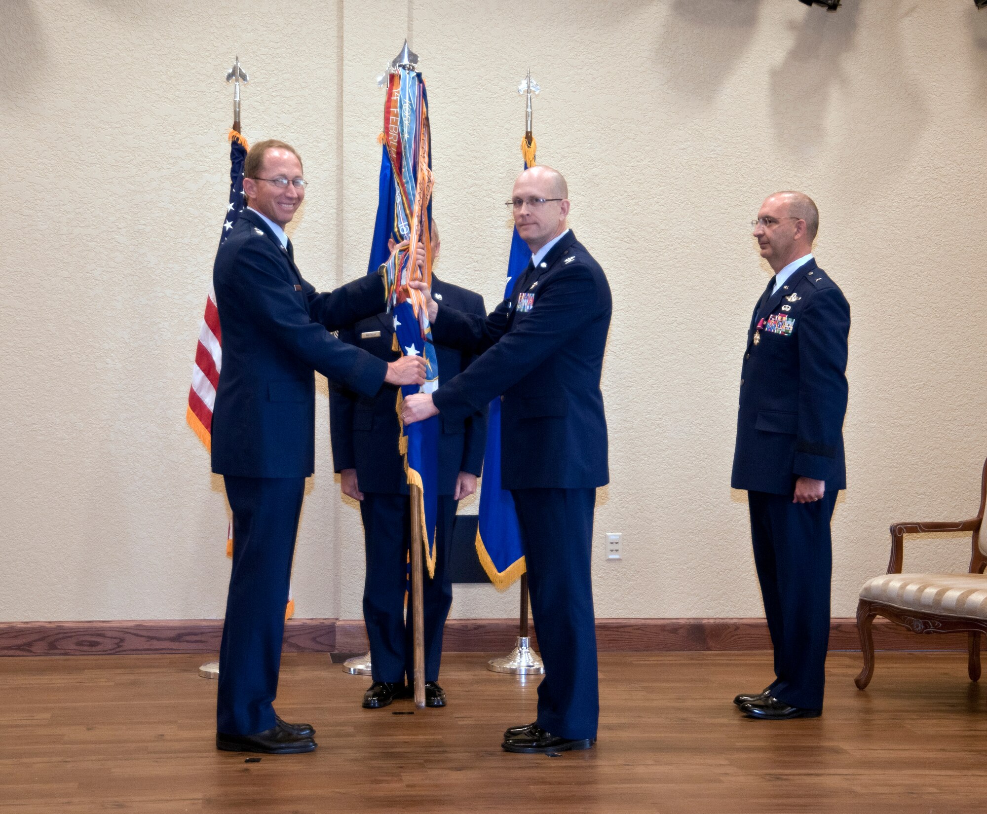 As the new 403rd Wing commander, Col. Jay Jensen accepts the 403rd Wing guidon from Maj. Gen. James Rubeor, 22nd Air Force commander, in a change of command ceremony held here May 12 at the Bay Breeze Event Center.  General Muscatell  commanded the 403rd Wing from January 2009 and accepted a position at Scott Air Force Base, Ill.  He relinquishes command to Colonel Jensen, who previously served in the 403rd Wing from April 1999 to July 2008.  (U.S. Air Force photo by Tech. Sgt. Tanya King)