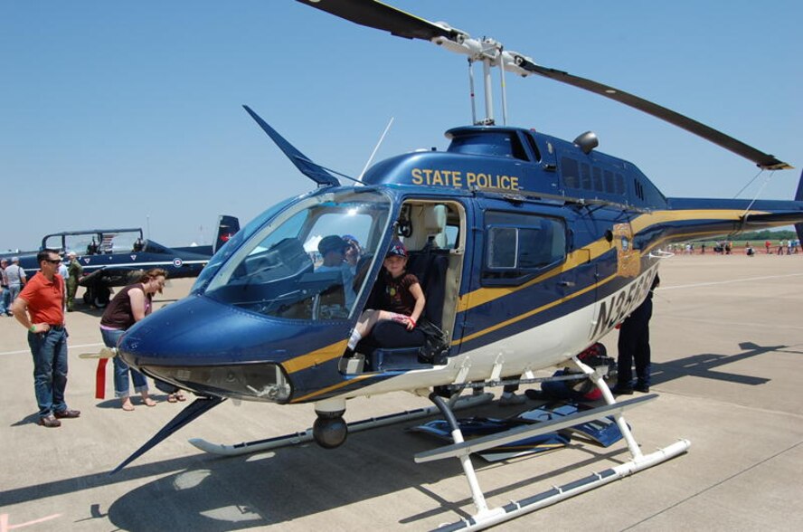 A young girl sits in the driver’s seat of a Louisiana State Police OH-58 helicopter. The Louisiana State Police and local police and sheriff’s offices all contributed various aircraft, vehicles and personnel to the air show as a show of the positive relationship Barksdale Air Force Base, La., enjoys with the surrounding communities. (courtesy photo by Staff Sgt. Matthew Connell, 26th Operational Weather Squadron) 
