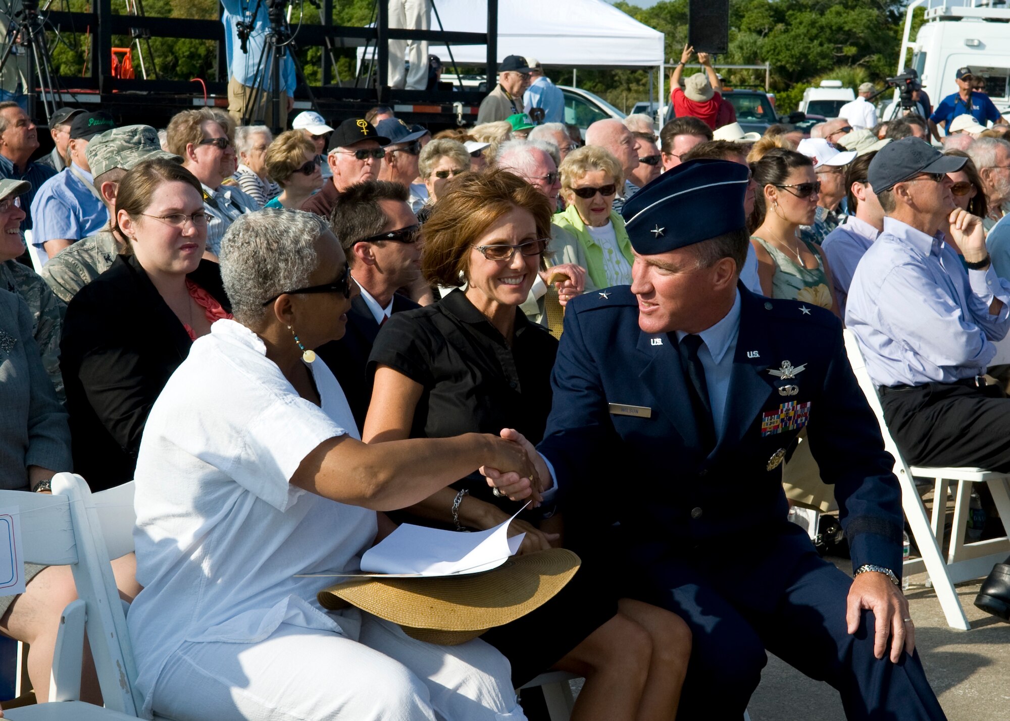 Brig. Gen. Ed Wilson, Commander of 45th Space Wing, shakes hands with Jacqueline Bolden, wife of NASA Administrator Charles Bolden, during the 50th anniversary celebration of the first American in space, Alan Shepard.
