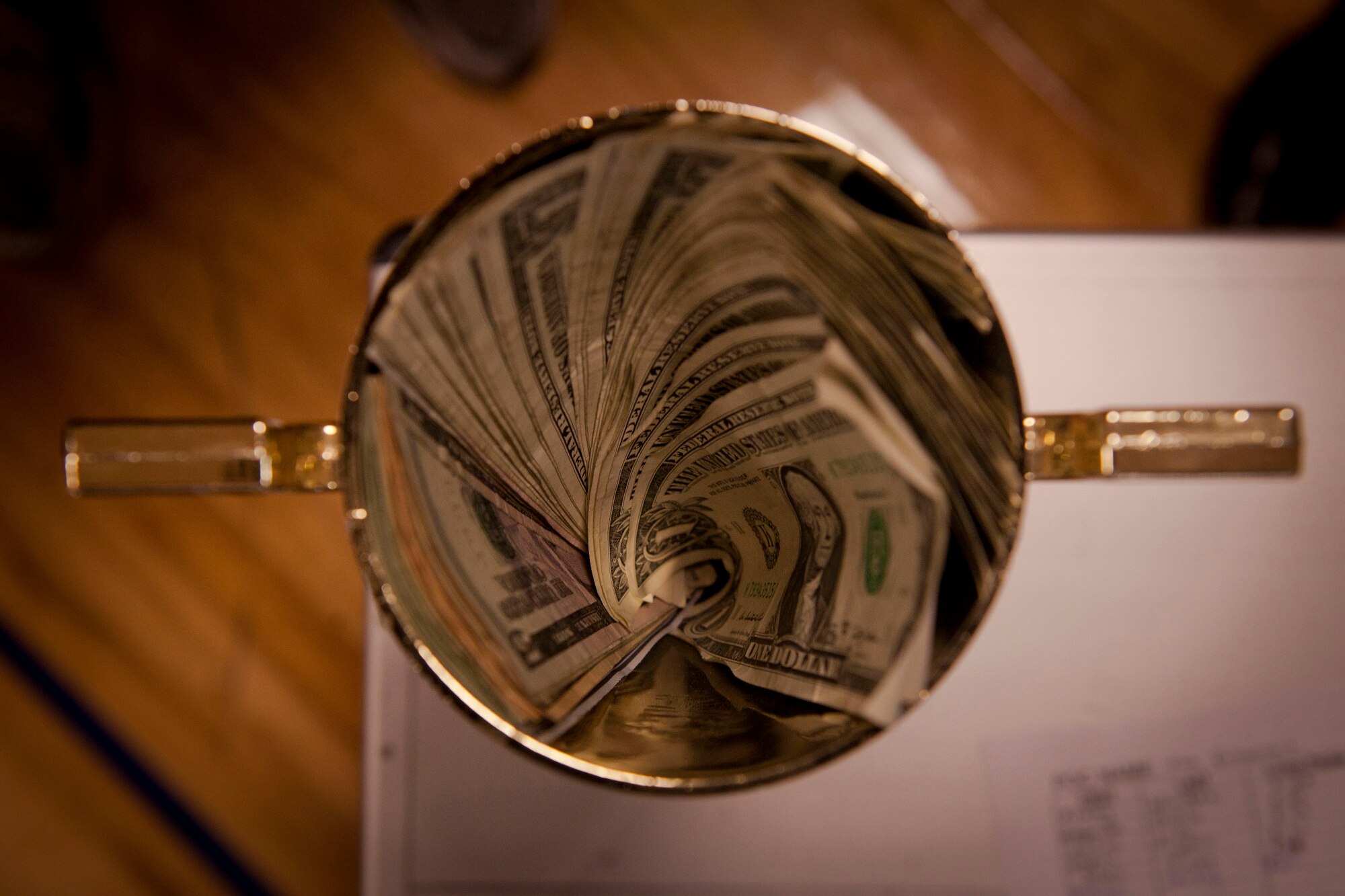 Money sits inside a trophy during Moody’s First Sergeants push-up challenge at Moody Air Force Base, Ga. May 13. The 38th Rescue Squadron completed the most push-ups within the ten-minute time frame, earning the trophy as well as the contents within the trophy. (U.S. Air Force photo/ Airman 1st Class Joshua Green)(RELEASED)
