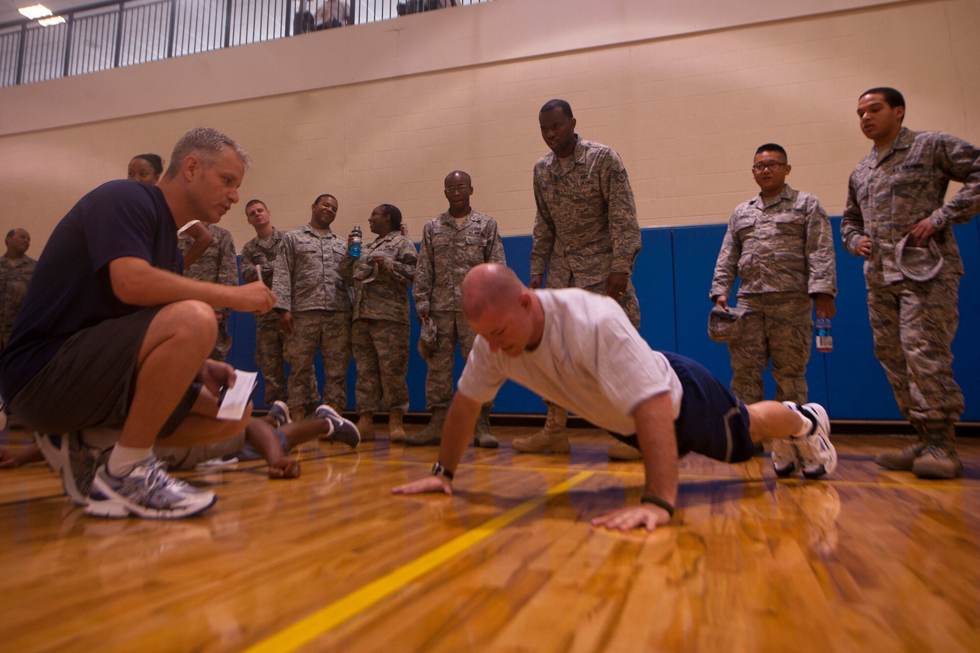 Airmen cheer on a fellow co-worker during Moody’s First Sergeants push-up challenge  at Moody Air Force Base, Ga. May 13. Squadron members with participants in the event were encouraged to motivate and provide support. (U.S. Air Force photo/ Airman 1st Class Joshua Green)(RELEASED)
