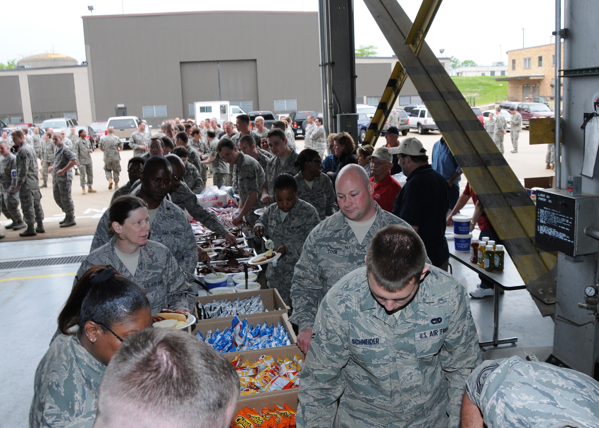 At the end of the work day, members of the 131st Bomb Wing at Lambert Air National Guard base enjoy a BBQ feast provided by the Veterans of Foreign Wars Post 2866, May 1.  A category EF4 tornado swept through Lambert Field, the South Side of Lambert Air National Guard Base, and several of the surrounding cities, April 22.  Damage estimates for the Lambert base are $10.5 million (U.S.)
Clean up efforts continue. (Photo by Master Sgt. Mary-Dale Amison)