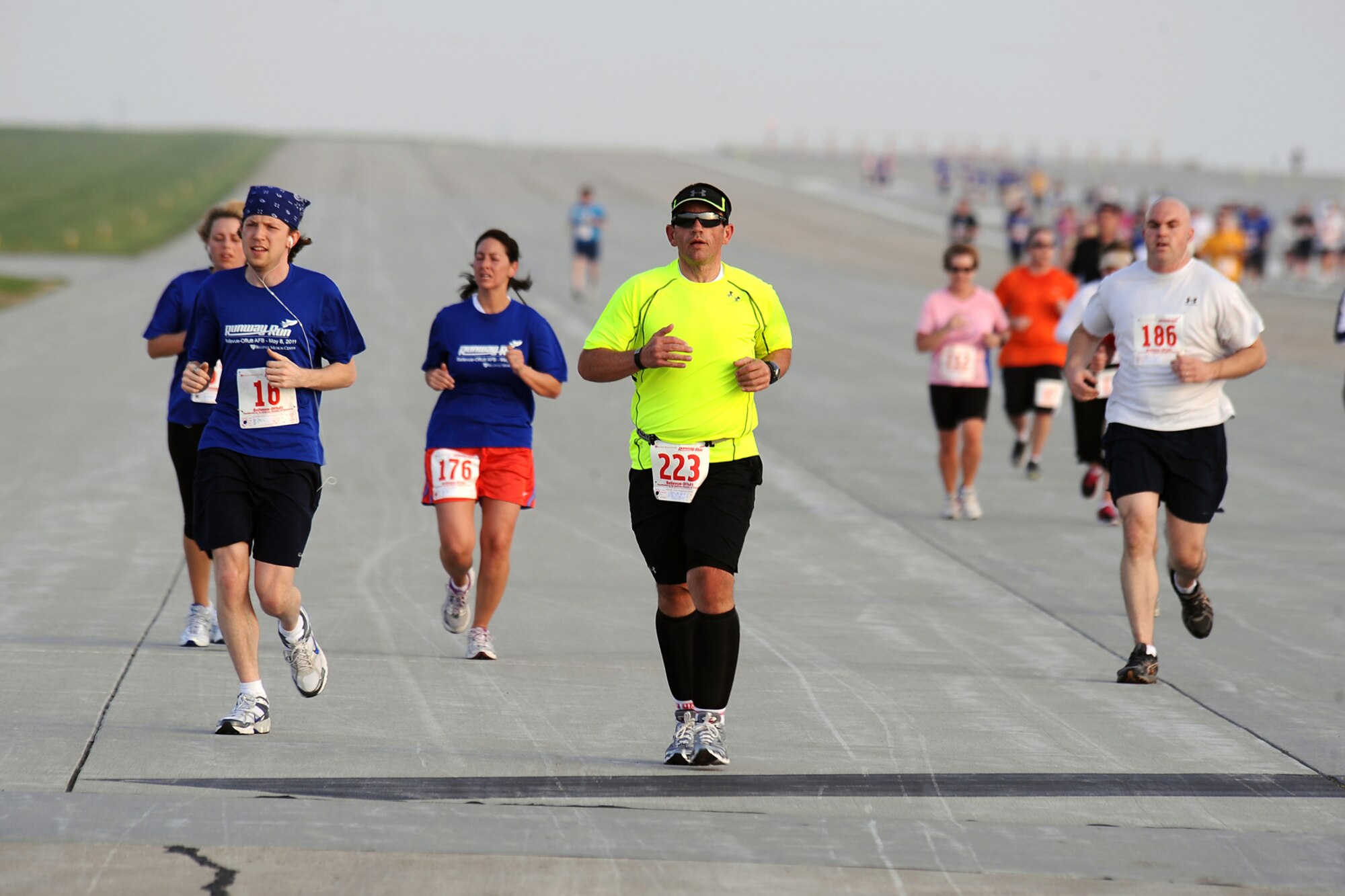 OFFUTT AIR FORCE BASE, Neb. -- People of a ages run down the Offutt runway as part of the seven-mile 4th Annual Bellevue-Offutt Runway Run held here May 8. Nearly 200 runners of all ages came to Bellevue to compete. U.S. Air Force Photo by Josh Plueger (released)
