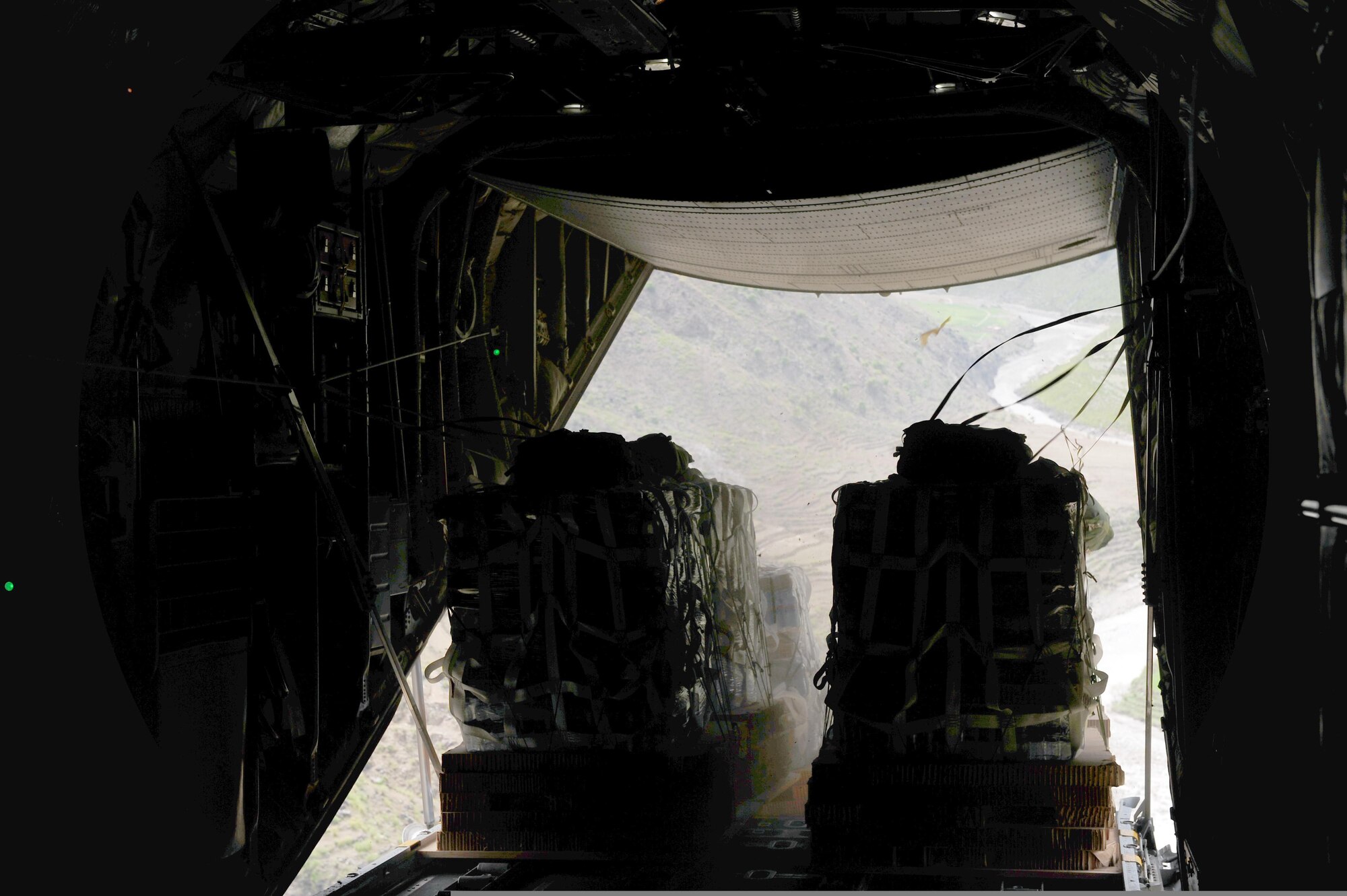 Pallets of water are dropped from a C-130 Hercules aircraft over Afghanistan on April 11, 2011. (U.S. Air Force Photo/Master Sgt. William Greer)
