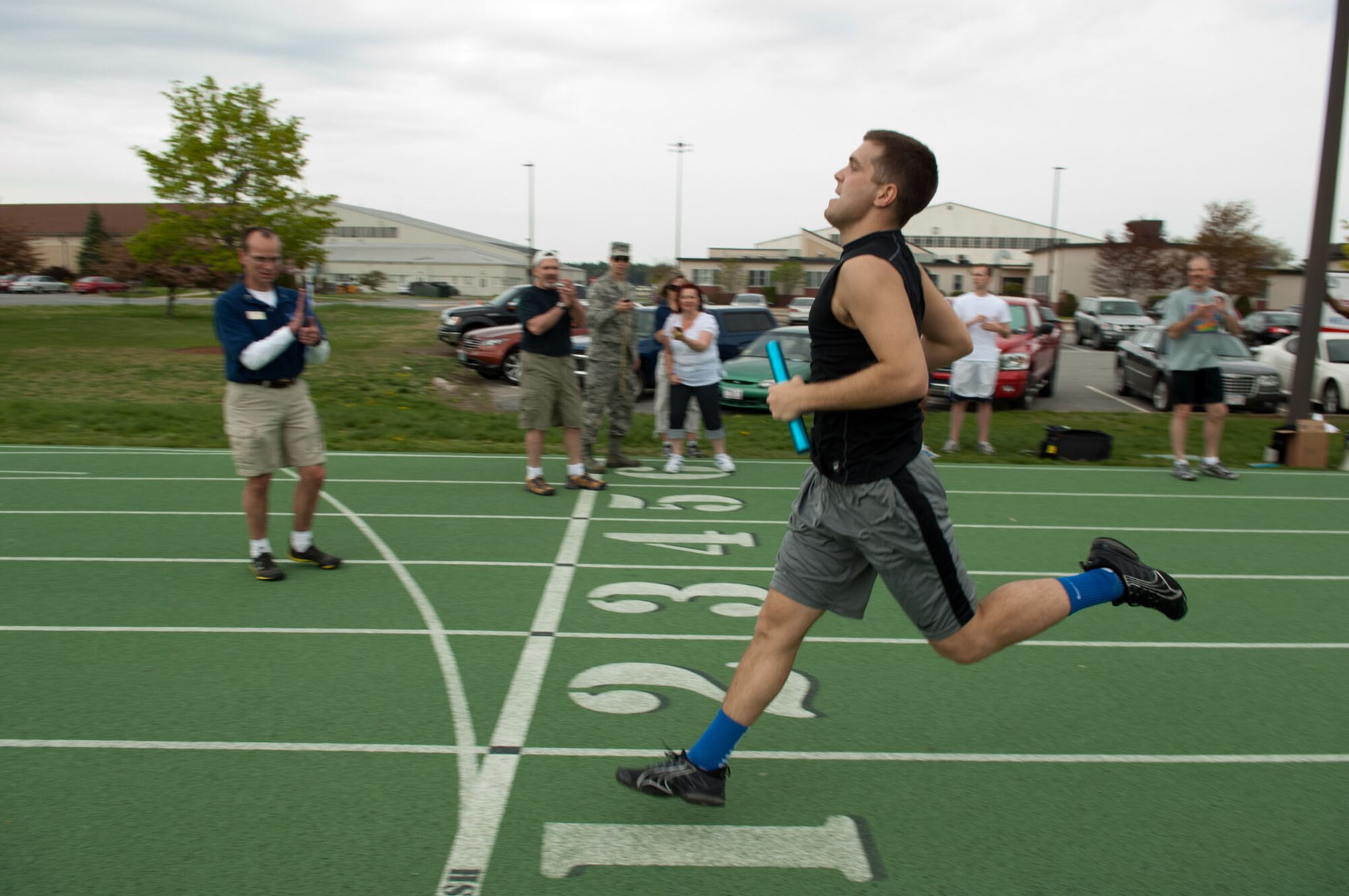 HANSCOM AIR FORCE BASE, Mass. – Staff Sgt. Sean Carty, from the 66th Medical Squadron, crosses the finish line during the baton relays at the track on May 3. Many team and individual activities took place last week, including golf, basketball, dodgeball, racquetball, a build-a-boat contest and more. The 66th Air Base Group took home Hanscom Olympics trophy for having the most points across all events and the Cyber/Netcentric Directorate won the Commander’s Cup. (U.S. Air Force photo by Rick Berry) 