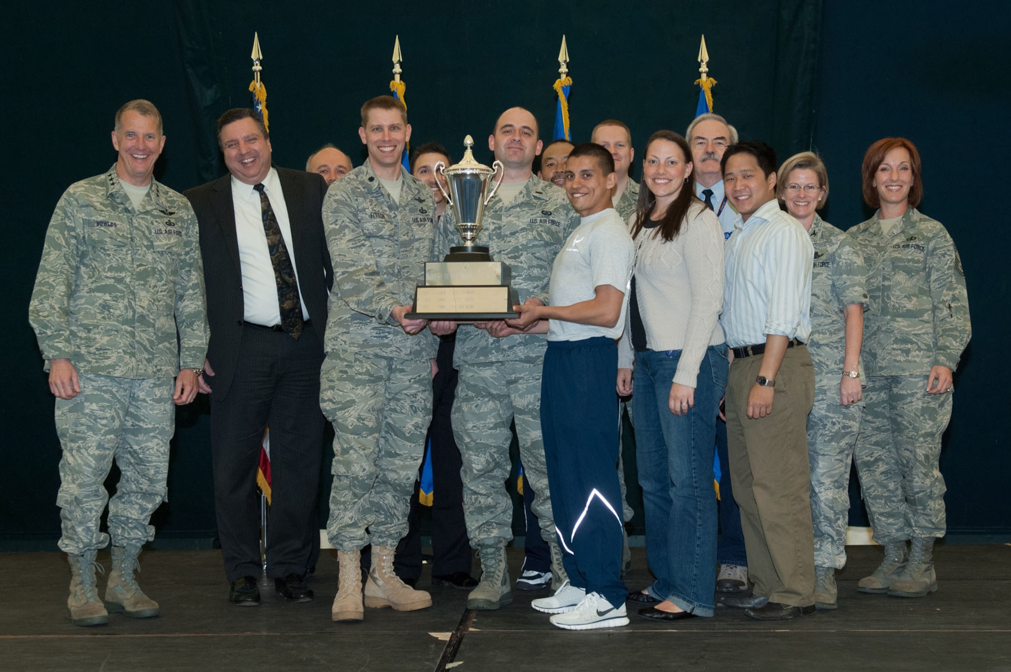 HANSCOM AIR FORCE BASE, Mass. – Members of the Cyber/Netcentric Directorate team accept the Commander’s Cup during the closing ceremonies of the Hanscom Olympics May 6. Many team and individual activities took place last week, including golf, basketball, dodgeball, racquetball, a build-a-boat contest and more. The 66th Air Base Group took home Hanscom Olympics trophy for having the most points across all events and the Cyber/Netcentric Directorate won the Commander’s Cup. (U.S. Air Force photo by Rick Berry) 