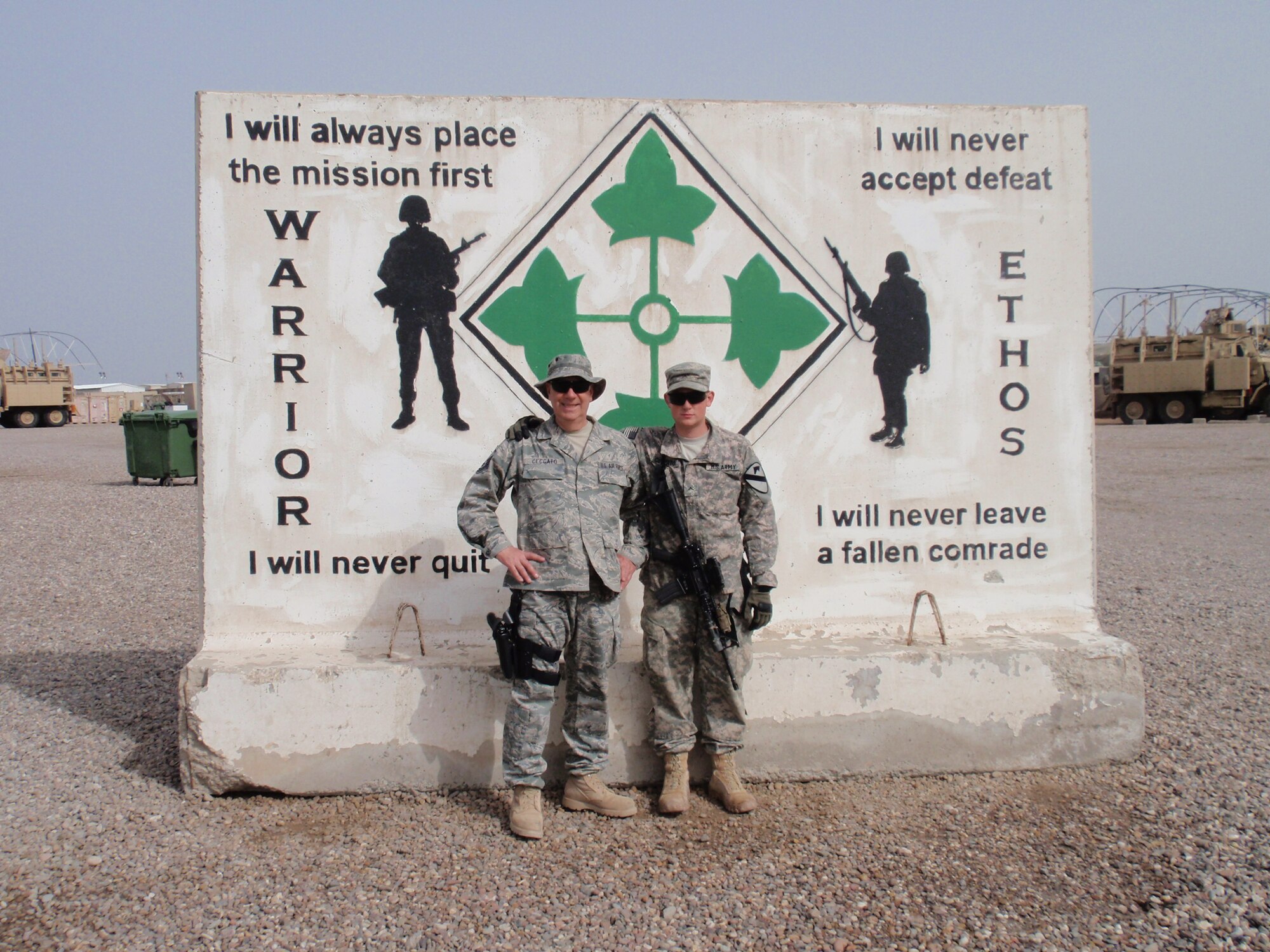 914th Maintenance  Group  Training Manager  U.S. Air Force Master Sgt. John Ceccato  and his son U.S. Army Private David Ceccato stand with each other near Basra, Iraq. The two servicemen found a way to reunite in the war zone after nearly a year of not seeing one another. 