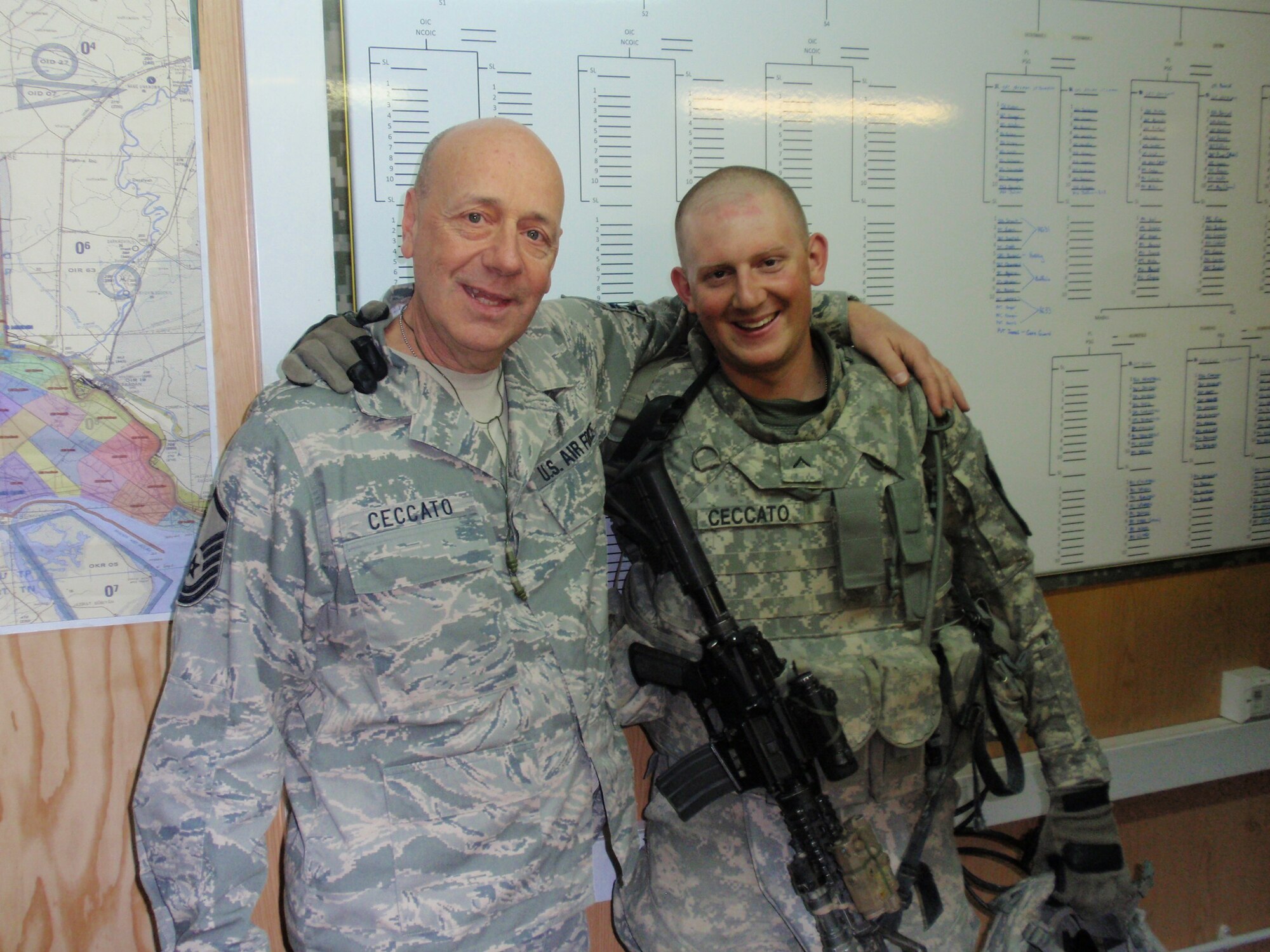914th Maintenance  Group  Training Manager  U.S. Air Force Master Sgt. John Ceccato  and his son U.S. Army Private David Ceccato stand with each other near Basra, Iraq. The two servicemen found a way to reunite in the war zone after nearly a year of not seeing one another. 
