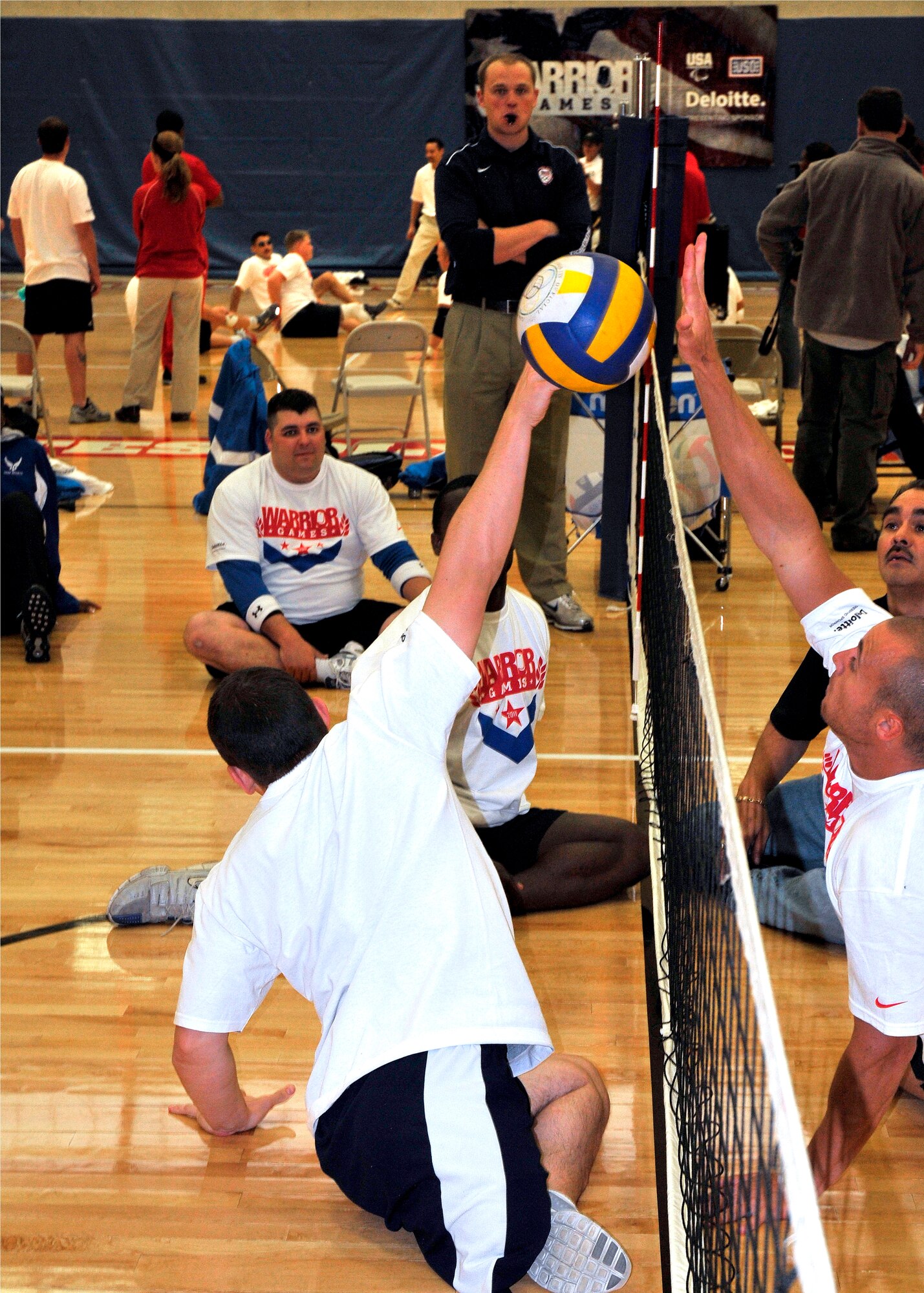 Matthew Pirrello, an Ohio University ROTC Cadet, (foreground) attempts to block Team Army’s spiked ball during a civic leader orientation during the 2011 Warrior Games training week in Colorado Springs. (U.S. Air Force Photo by Lt.Col. Richard Williamson.)