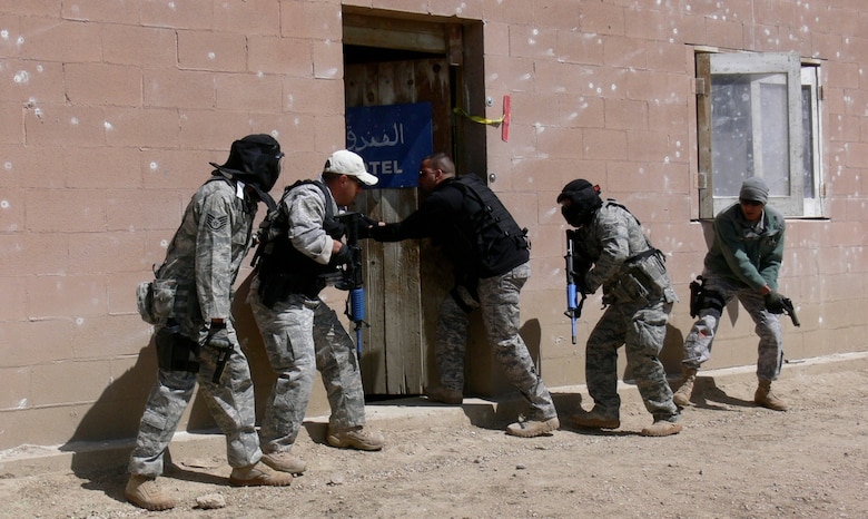 A five-member team enters a building during an Active Shooter Instructor Course May 2-5. Airmen from the 21st Security Forces Squadron became certified instructors, along with 20 other active duty and Department of Defense police officers, after a five-day, 48-hour training course put on by a Washington-based private company and held at Fort Carson Army Installation’s Range 60. The 21st SFS certified active shooter instructors provide on-going training for the squadron. (U.S. Air Force photo/Monica Mendoza)