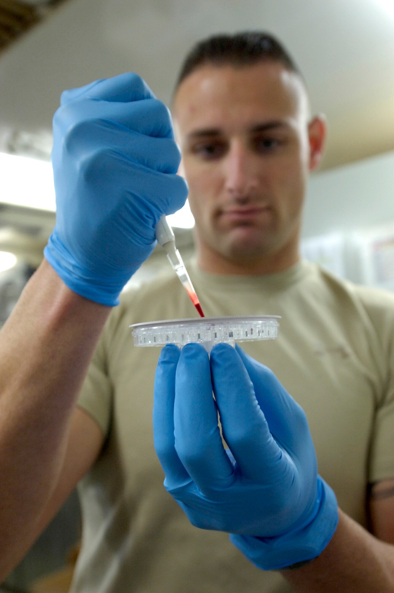 KIRKUK REGIONAL AIR BASE, Iraq – Staff Sgt. Joseph Jenkins, 321st Expeditionary Medical Squadron medical lab technician, prepares a blood sample for analysis May 11. The 321st EMEDS is the principal surgical unit for American forces in all of northern Iraq, treating military and civilian patients alike. Sergeant Jenkins, originally from Bloomington, Minn., is deployed from Eglin Air Force Base, Fla. (U.S. photo by Tech. Sgt. Randy Redman)