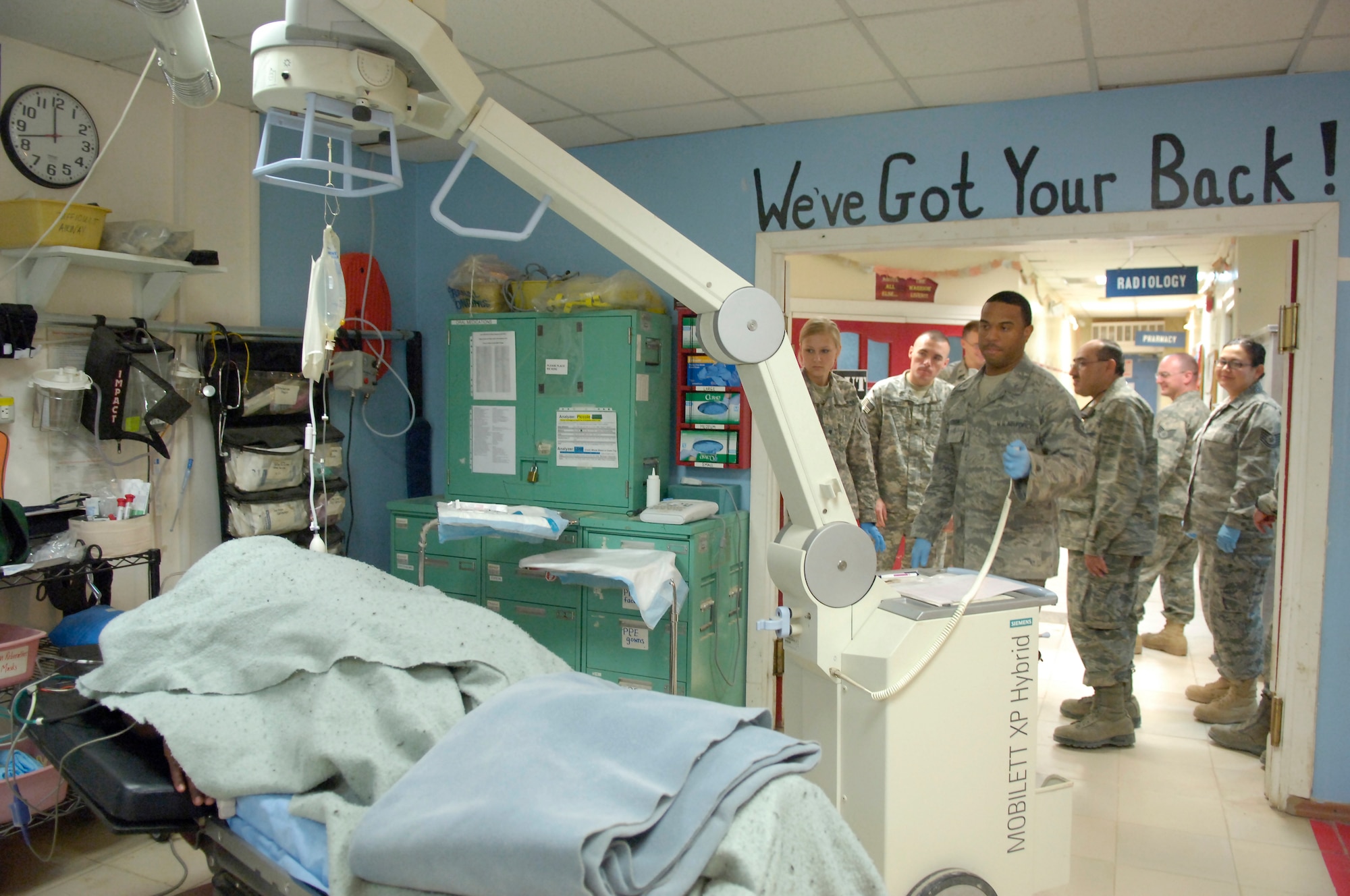 KIRKUK REGIONAL AIR BASE, Iraq – Tech. Sgt. Eric Person, 321st Expeditionary Medical Squadron radiology technician, uses a portable X-ray machine on a patient May 11. The 321st EMEDS is the principal surgical unit for American forces in all of northern Iraq, treating military and civilian patients alike. Sergeant Person, originally from Phenix City, Ala., is deployed from Eglin Air Force Base, Fla. (U.S. photo by Tech. Sgt. Randy Redman)