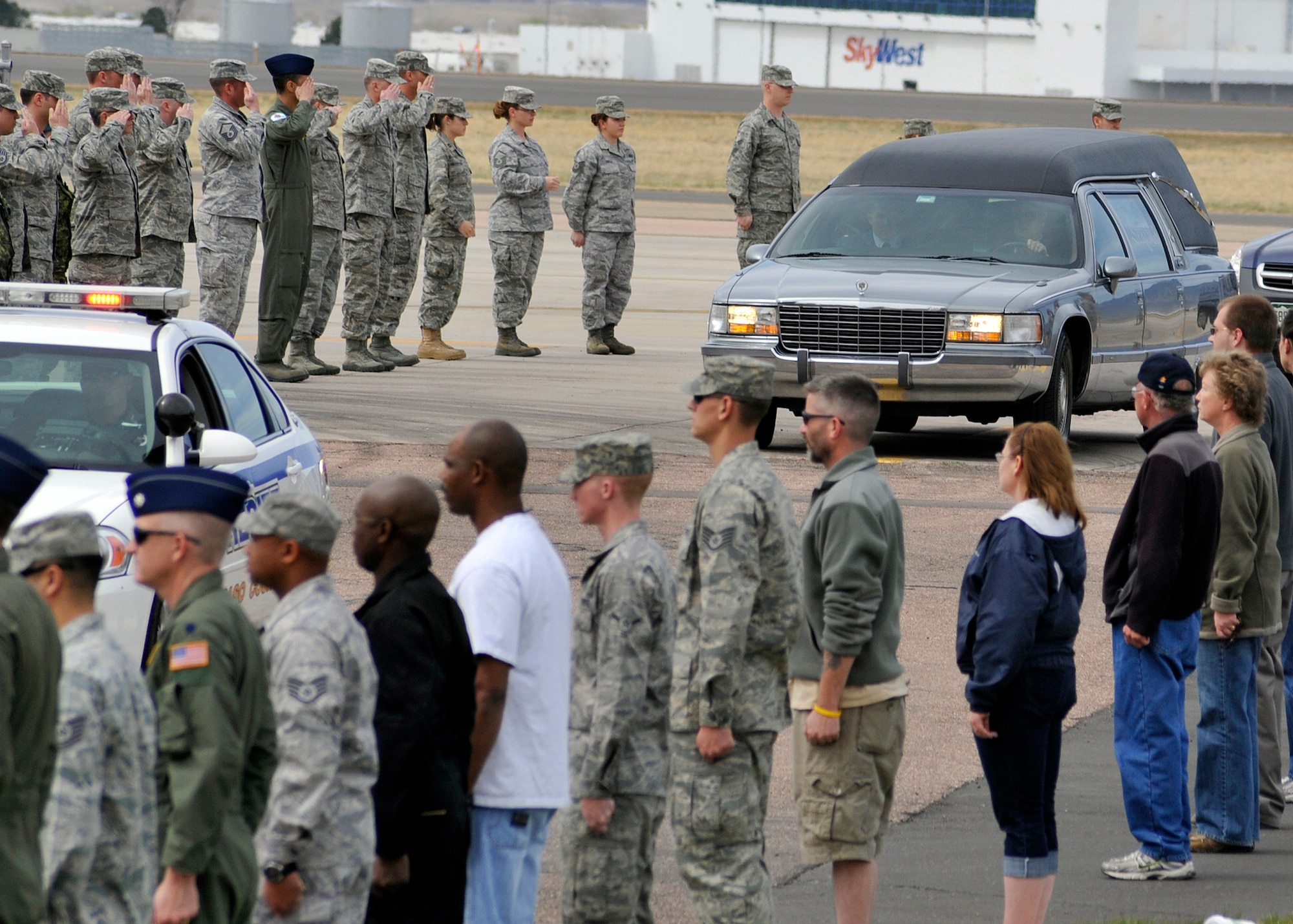 Servicemembers and civilians from Peterson Air Force Base line Peterson Boulevard May 6, 2011, for the return of Maj. David L. Brodeur, a fallen Airman who was killed in Afghanistan in April. Hundreds of Airmen lined the street from the flight line to the north gate to honor his service, commitment and dedication to the nation. Major Brodeur was a U.S. Air Force Academy graduate, and a full military honors funeral is scheduled for May 17 at USAFA. (U.S. Air Force photo/Rob Bussard)