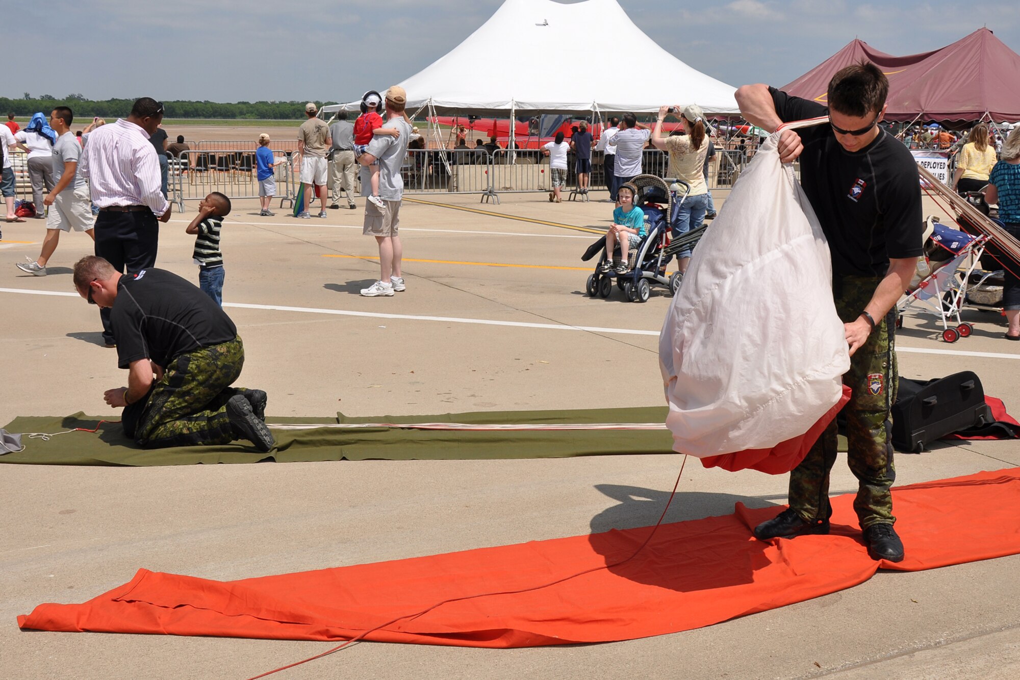 (L to R) Private Michael Levandier and Corporal Corey Douglas of the Canadian Army, repack their parachutes after a performance at the 2011 Defenders of Liberty Air Show on Barksdale Air Force Base, La., May 8, 2011. Private Levandier is from Oromocto, New Brunswick, which is a Province of Canada and Corporal Douglas hales from British Columbia, Canada. (U.S. Air Force photo/Tech. Sgt. Jeff Walston)