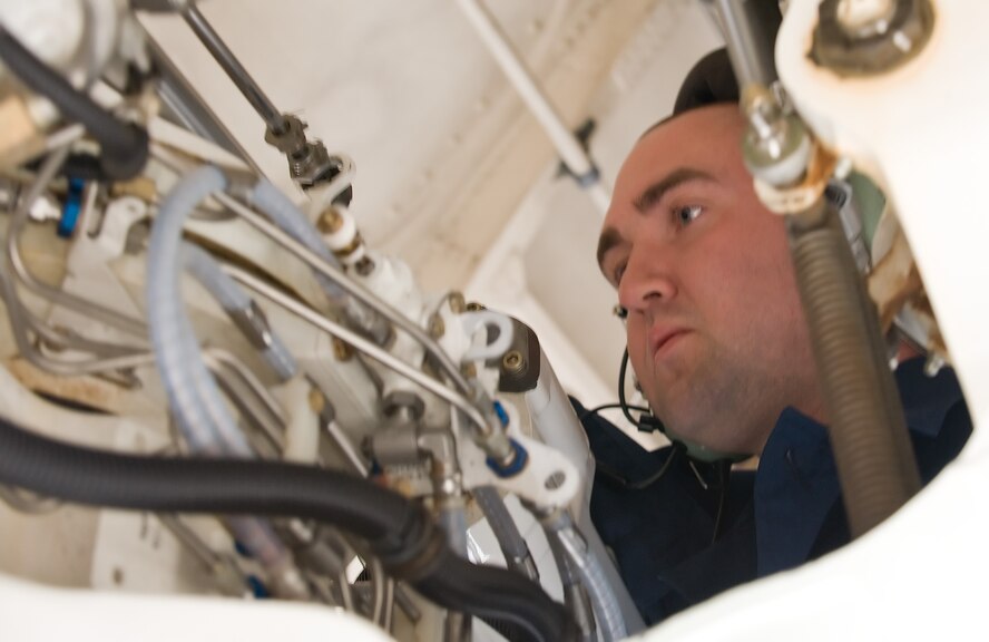 Staff Sgt. Rob Sheppard, 436th Aircraft Maintenance Squadron flying crew chief, reaches far into a C-5B Galaxy’s wheel well to make sure all nuts and bolts are secure May 12, 2011, at Dover Air Force Base, Del. The pre-flight inspections performed by the 436 AMXS crew chiefs are rigorous and include even small parts. (U.S. Air Force photo by Airman 1st Class Jacob Morgan)