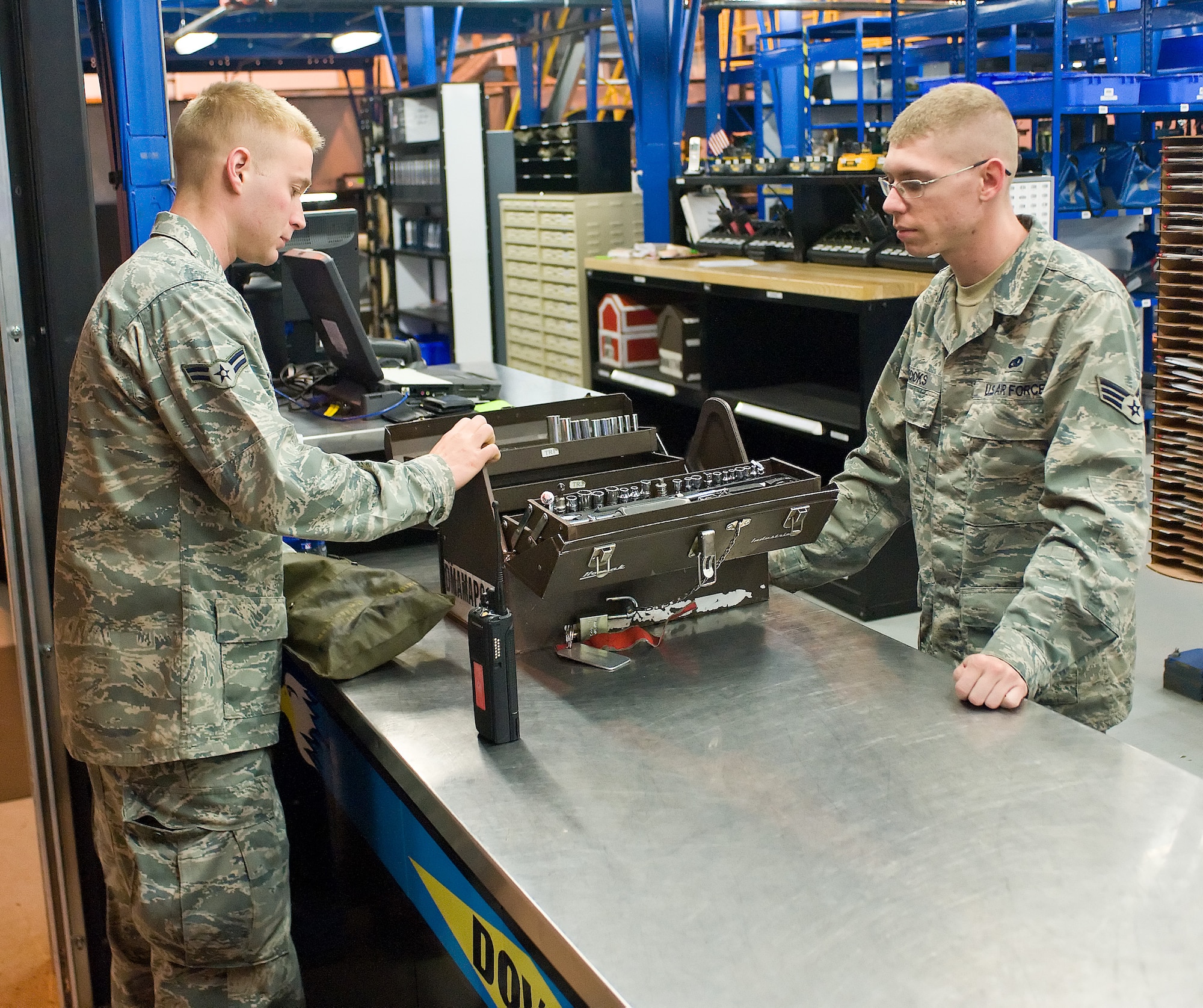 Airman 1st Class Cole Carlton (left) and Senior Airman Joseph Brooks, both with the 436th Aircraft Maintenance Squadron, exchange tools for daily maintenance on the flightline May 12, 2011, at Dover Air Force Base, Del. The Airman of the 436 AMXS maintain all C-5 Galaxys and Super Galaxys in the 436th Airlift Wing’s inventory. (U.S. Air Force photo by Airman 1st Class Jacob Morgan)