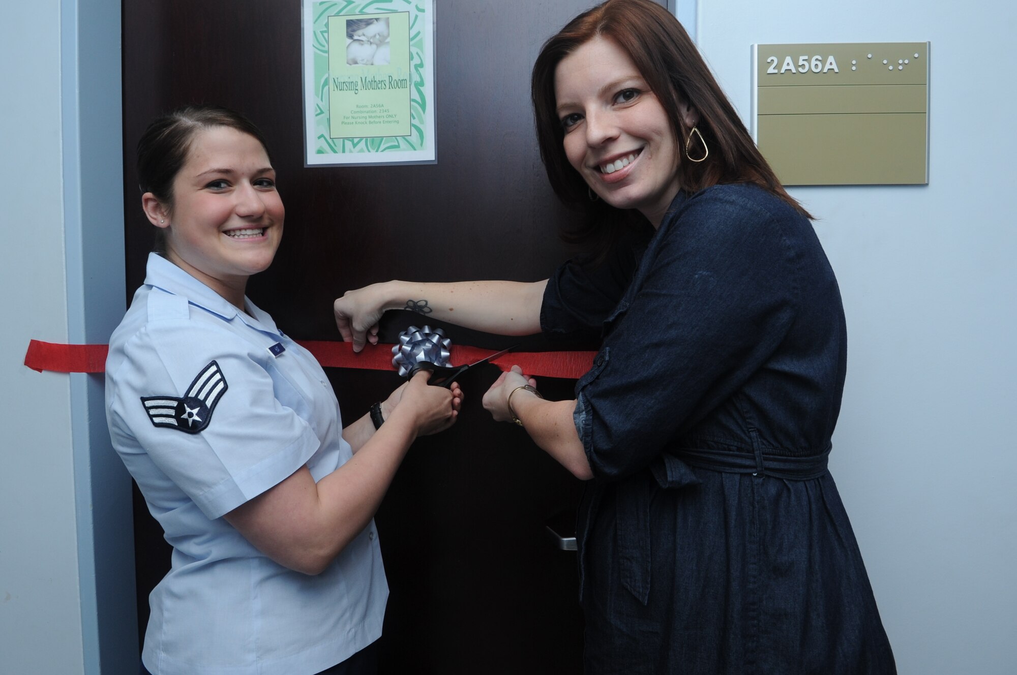 Senior Airman Katelin Hunt and Katrina Gonzalez, both from the 39th Medical Operations Squadron cut the ribbon during the opening ceremony of the 39th Medical Group’s nursing room May 2, 2011 at Incirlik Air Base, Turkey. The intent of the nursing room is to give Incirlik’s nursing mothers a comfortable and private place to breast feed their babies or to safely pump the milk for later use. (U.S. Air Force photo by Tech. Sgt. Valda Wilson/released)