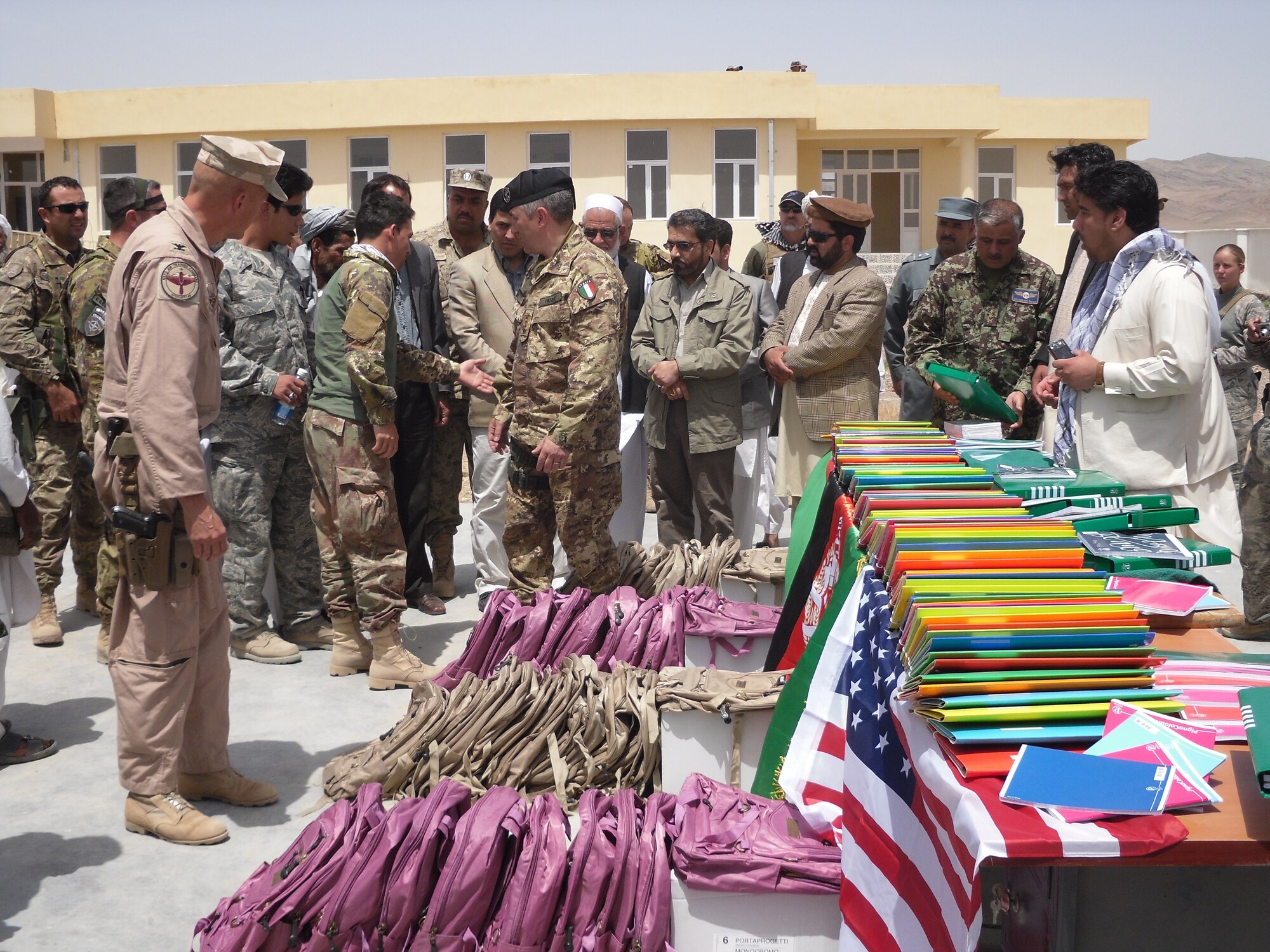 Staff from the Mandel School were presented with new backpacks and other school supplies May 12 for school students.The donations were from individual volunteers stateside. Airmen from the 838th Air Expeditionary Advisory Group worked in conjunction with coalition partners and Afghan allies to help open the school in the village of Mandel located Southwest of Shindand in the Herat Province. (U.S. Air Force photo by Lt. Col. Joe Del Campo)