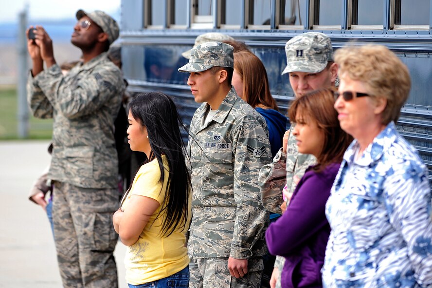 Airmen and their spouses and family members watch as Airmen of the 28th Civil Engineer Squadron fire department put out a simulated aircraft fire during Spouse Appreciation Day at Ellsworth Air Force Base, S.D., May 6, 2011.  The 28th CES provides the necessary assets and skilled personnel to prepare and sustain installations throughout the world. (U.S. Air Force photo/Staff Sgt. Marc I. Lane)
