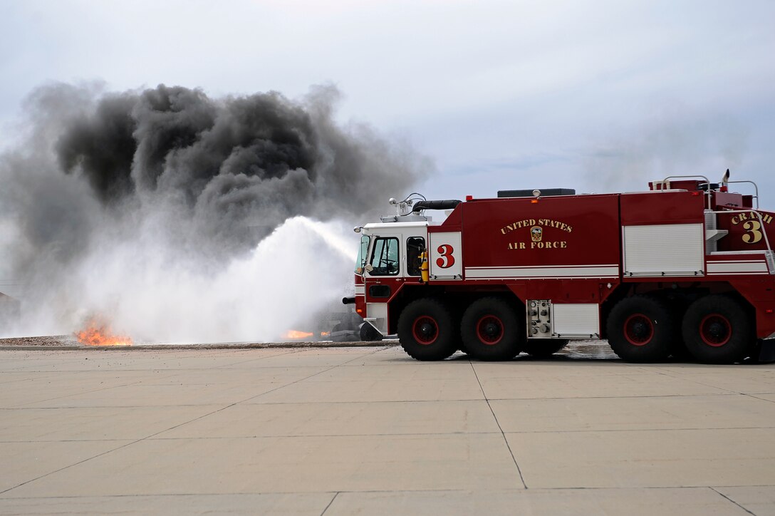 Airmen of the 28th Civil Engineer Squadron fire department put out a simulated aircraft fire during Spouse Appreciation Day at Ellsworth Air Force Base, S.D., May 6, 2011.  Approximately 150 Ellsworth spouses came together to participate in a wide array of activities designed to thank them for all they do and the important role they play in the lives of their Airmen. (U.S. Air Force photo/Staff Sgt. Marc I. Lane)