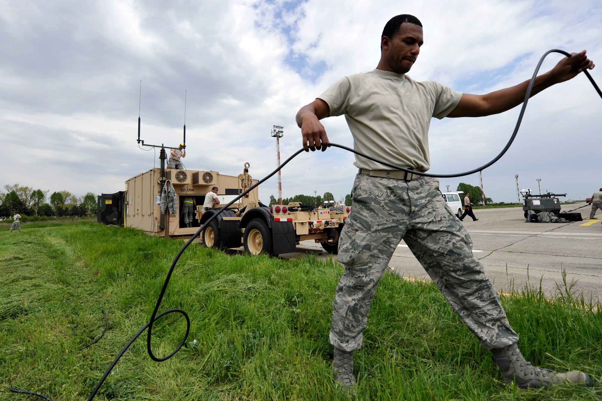 Staff Sgt. Letray Womble, radio frequency specialist with the 621st Contingency Response Element establishes communications equipment at Mihail Kogalniceanu Air Base, Romania, May 10.  Fifty-four members of the 621st Contingency Response Wing deployed here to extend airfield capability supporting multi-modal operations during a U.S. Transportation Command proof-of-principle evaluation. The process is expected to demonstrate the feasibility of using the air base as a hub for equipment flowing into and out of Afghanistan.  (U.S. Air Force photo by Master Sgt. Laura K. Deckman/released)