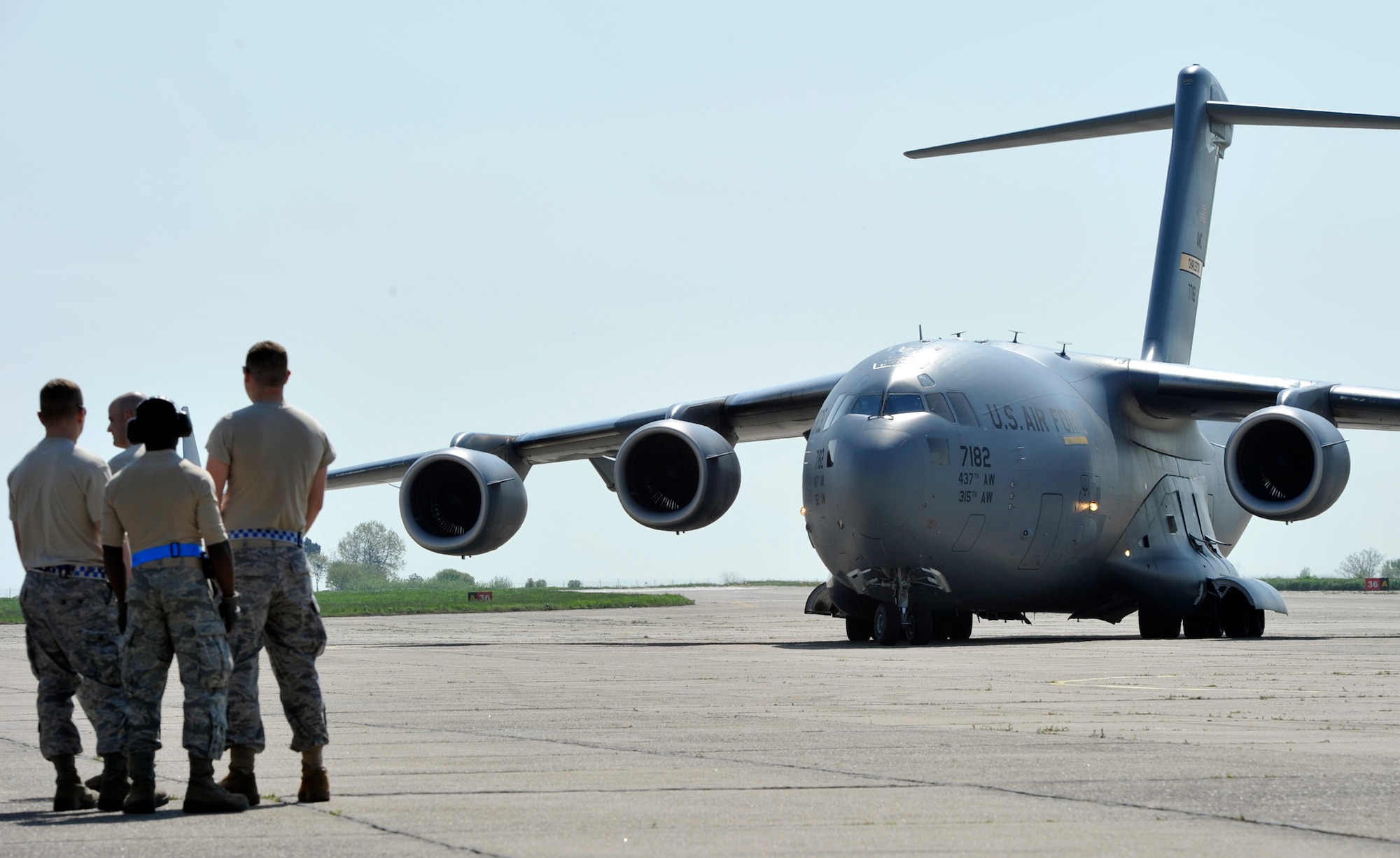 Air transportation specialists with the 621st Contingency Response Element prepare to off-load a C-17 Globemaster III as it arrives at Mihail Kogalniceanu Air Base, Romania, May 9.  Fifty-four members of the 621st Contingency Response Wing deployed here to extend airfield capability supporting multi-modal operations during a U.S. Transportation Command proof-of-principle evaluation. The process is expected to demonstrate the feasibility of using the air base as a hub for equipment flowing into and out of Afghanistan.  (U.S. Air Force photo by Master Sgt. Laura K. Deckman/released)