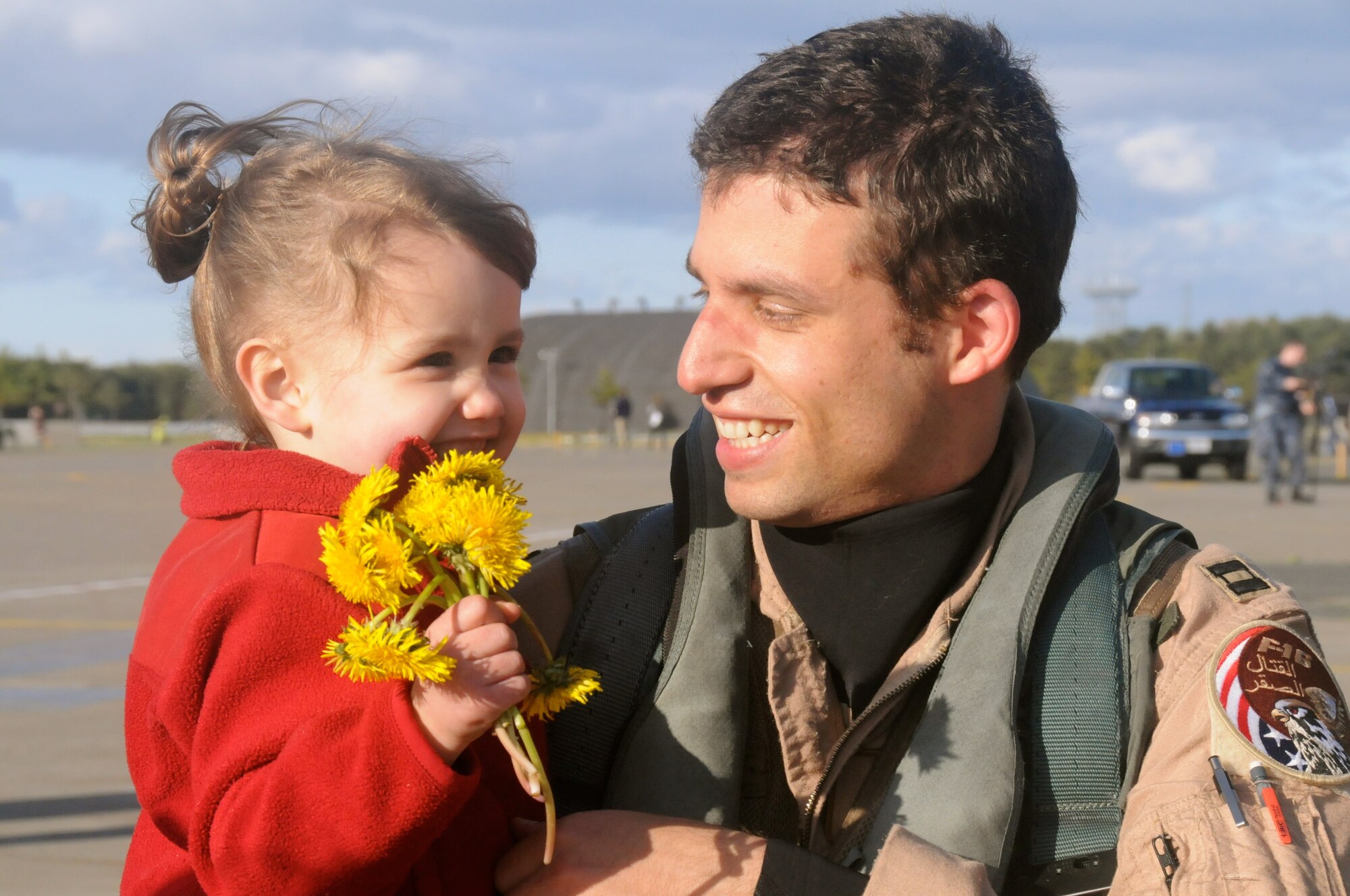 MISAWA AIR BASE, Japan -- Capt. Tyler Young, 13th Fighter Squadron pilot, greets his daughter Clara after arriving home from a deployment, May 13. The 13th FS and more than 300 Airmen from the 35th Maintenance Group deployed for more than seven months to Balad Air Base, Iraq. (U.S. Air Force photo/Staff Sgt. Rachel Martinez)