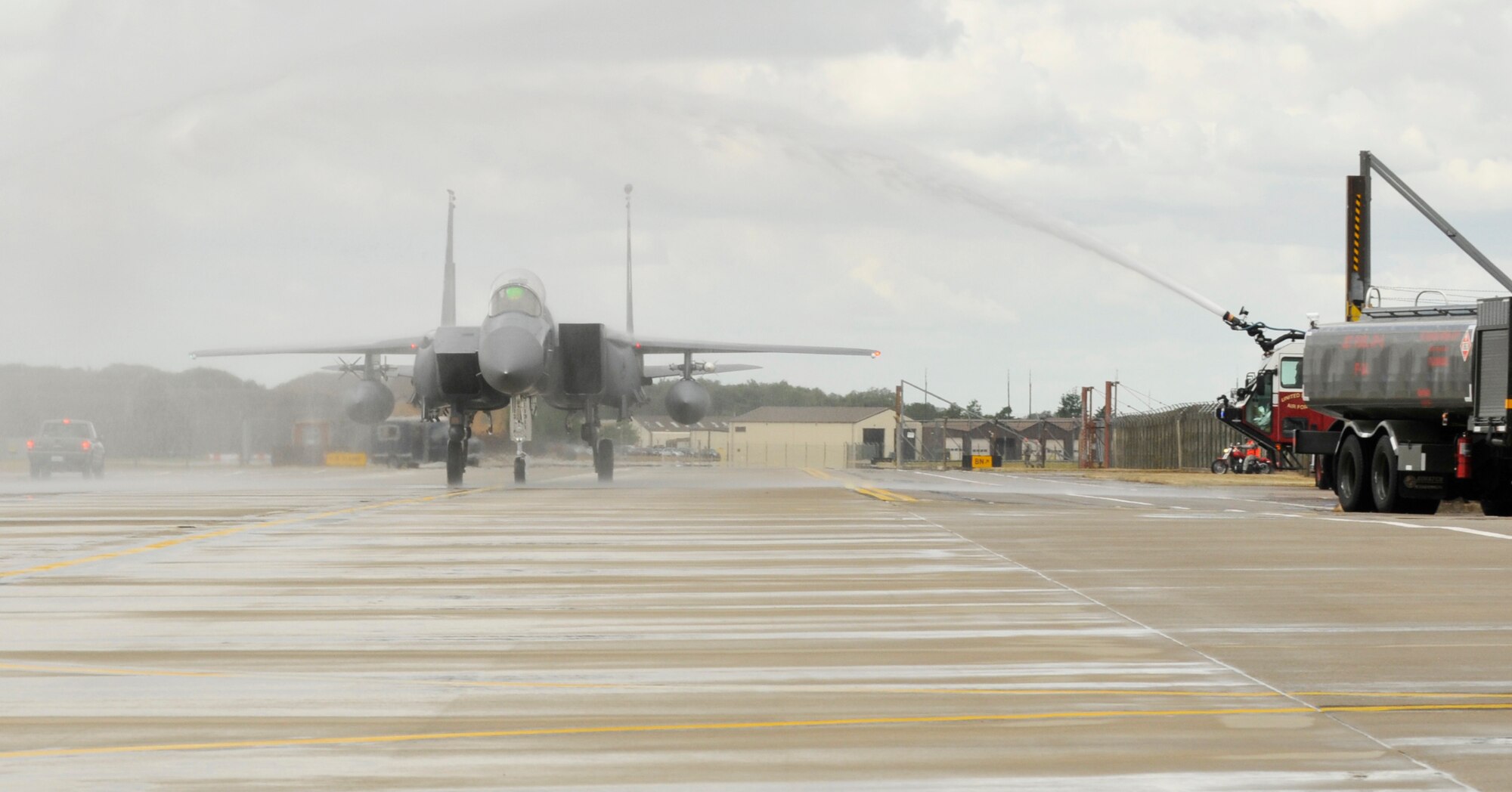 ROYAL AIR FORCE LAKENHEATH, England -  Maj. Gen. Jack Egginton, U.S.Air Forces in Europe director of Air and Space Operations, Ramstein Air Base, Germany,taxis a F-15E Strike Eagle through a water arch after his fini-flight on May 12, 2011. General Egginton finishes his Air Force career as a command pilot with more than 3,600 flying hours, including 480 combat hours flying close air support for coalition ground forces in Afghanistan and Iraq. (U.S. Air Force photo/Senior Airman Tiffany M. Deuel)