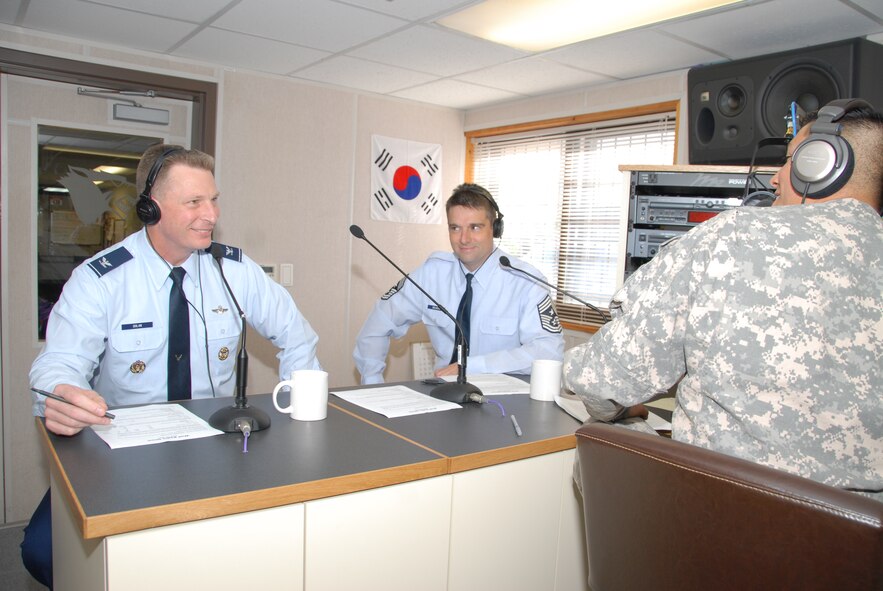 KUNSAN AIR BASE, Republic of Korea -- Col. John Dolan, former 8th Fighter Wing commander, and Chief Master Sgt. Scott Delveau, 8th FW command chief, talk about Colonel Dolan’s assignment to the Wolf Pack over the last year during “The Wolf Show” at Armed Forces Network - Kunsan here May 13. This was Colonel Dolan’s last appearance on the show during his tour at Kunsan. (U.S. Air Force photo/Capt. Sheryll Klinkel)