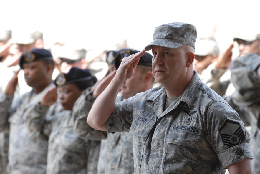KUNSAN AIR BASE, Republic of Korea -- Wolf Pack members salute their new leader, Col. Scott Pleus, 8th Fighter Wing commander, during the wing change of command ceremony in Hangar 3 here May 13. (U.S. Air Force photo/Senior Airman Benjamin Stratton)