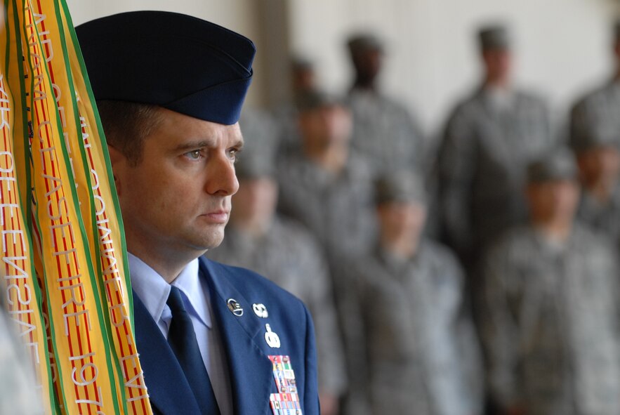 KUNSAN AIR BASE, Republic of Korea -- Chief Master Sgt. Scott Delveau, 8th Fighter Wing command chief, bears the wing’s guidon during the wing change of command ceremony in Hangar 3 here May 13. (U.S. Air Force photo/Senior Airman Benjamin Stratton)