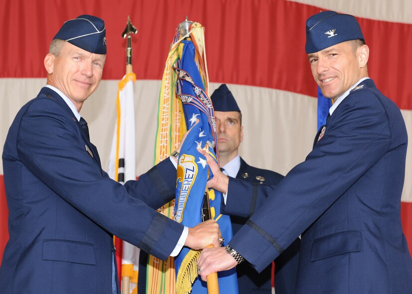 KUNSAN AIR BASE, Republic of Korea -- Lt. Gen. Jeffrey Remington passes the guidon to Wolf 51, Col. Scott Pleus, commander of the 8th Fighter Wing, during the wing change of command ceremony in hanger 3 here May 13. General Remington is the Deputy Commander, United Nations Command Korea; Deputy Commander, U.S. Forces Korea; Commander, Air Component Command, Republic of Korea; U.S. Combined Forces Command; and 7th Air Force commander. (U.S. Air Force photo/Senior Airman Ciara Wymbs)