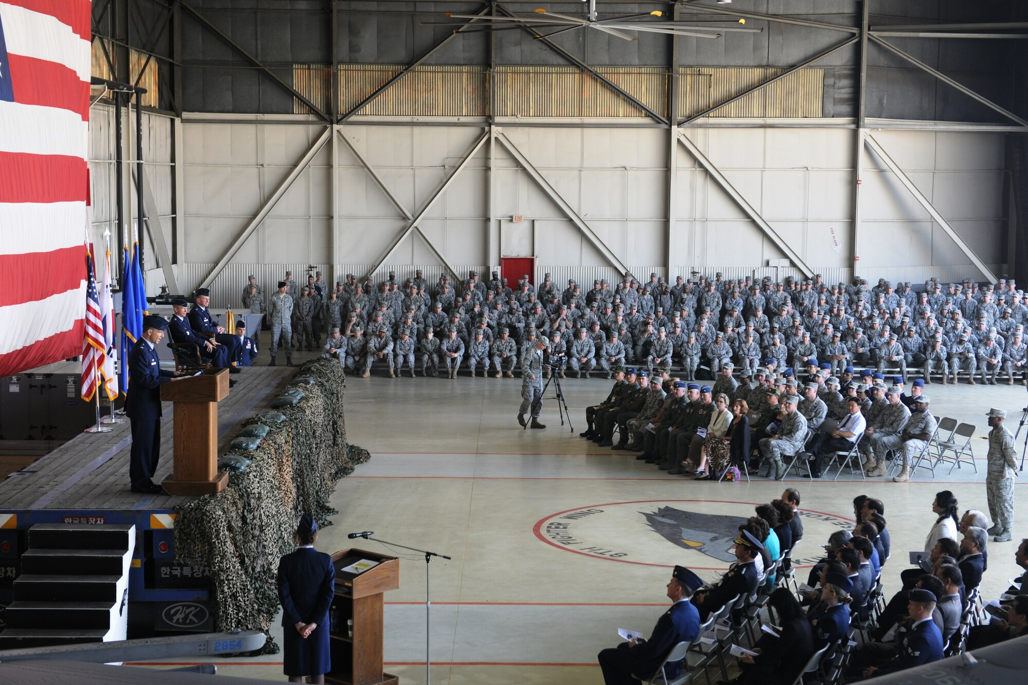 KUNSAN AIR BASE, Republic of Korea -- Col. Scott L. Pleus assumed command of the 8th Fighter Wing from Col. John L. Dolan during a change of command ceremony in hangar 3 here May 13. The mission of the 8th FW is to deter North Korean aggression, and if deterrence fails, to defend the base, accept follow-on forces and take the fight north. (U.S. Air Force photo/Senior Airman Brittany Y. Bateman)