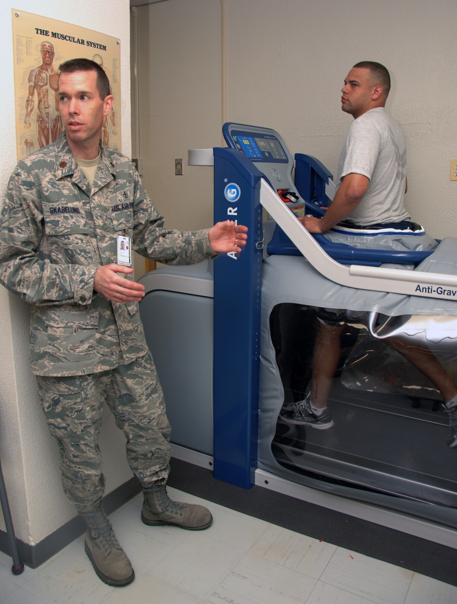 YOKOTA AIR BASE, Japan - Major Jeremy Skabelund, 374th Surgical Operations Squadron physical medicine element chief (left), explains how the AlterG Zero-Gravity Treadmill operates as Airman 1st Class Tony Jenkins, 374th MSGS physical therapy technician, demonstrates how to utilize the treadmill at Yokota Air Base, Japan May 11, 2011. (U.S. Air Force Photo/Airman 1st Class Katrina R. Menchaca)
