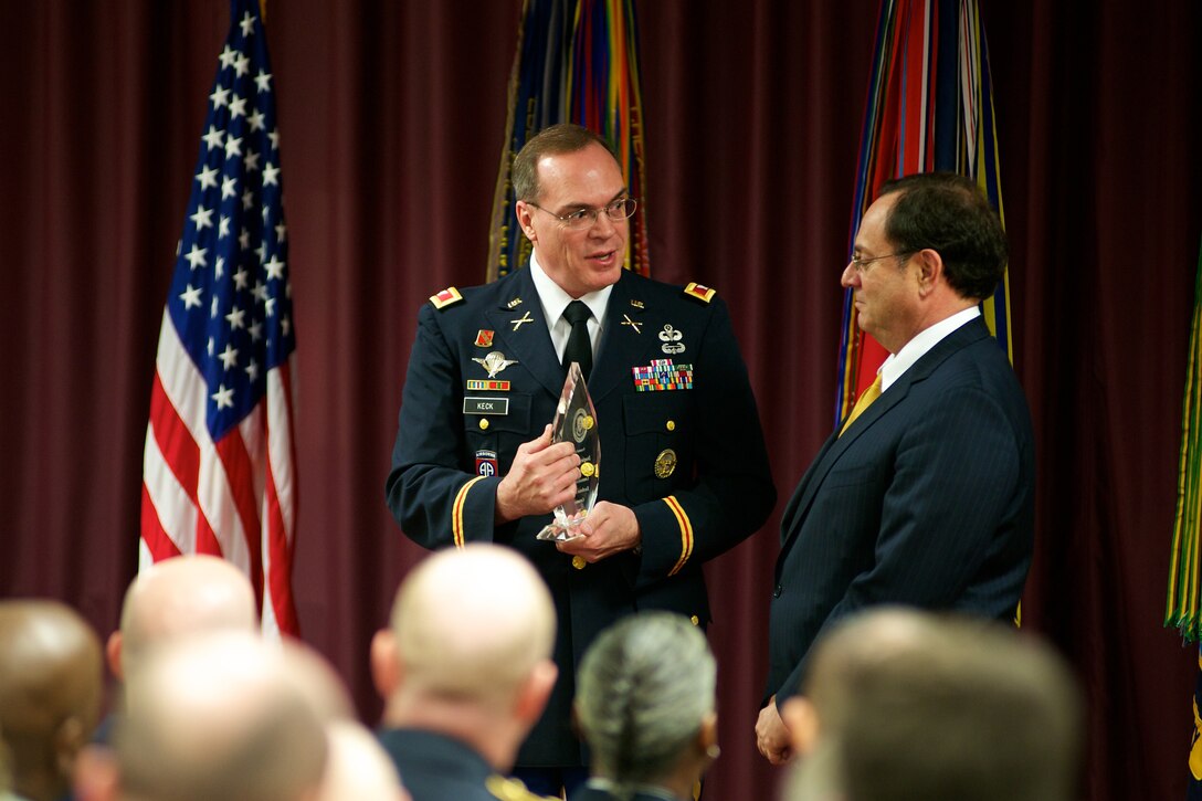 U.S. Army Colonel Gary L. Keck speaks to the Assistant Secretary of Defense for Public Affairs Douglas B. Wilson during the 2011 Communicators of Excellence awards ceremony on May 13, 2011 at the Defense Information School on Ft. George G. Meade, Md.  The Communicators of Excellence awards are presented annually to winners from the Visual Information Awards Program and the Thomas Jefferson Awards Program.  The VIAP is designed to recognize, reward, and promote excellence among military photographers, videographers and graphic artist for their achievements in the military visual information community. Additionally the TJ recognizes military and civilian employee print and broadcast journalist for outstanding achievements in furthering the objectives of the Department of Defense.  U.S Air Force Photo by Staff Sgt. Joshua T. Jasper