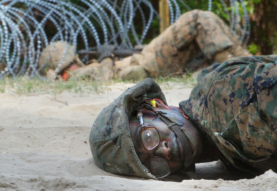 A Marine recruit crawls through the sand while going through The Crucible at Parris Island, S.C., May 13, 2011.  