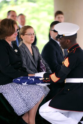 Linda Townsend accepts a folded flag, which symbolizes her husband’s service to his country, during Cpl. Daniel Townsend’s funeral at Arlington National Cemetery May 13.
