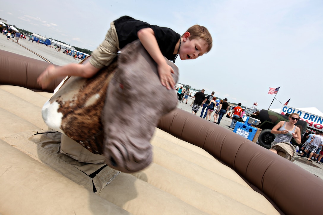 A guest of the 2011 Sounds of Freedom Air Show flies off a mechanical bull as it thrashes about at Marine Corps Air Station New River, May 14.  The show included about 20 performances and 30 static displays to celebrate the centennial of naval aviation.