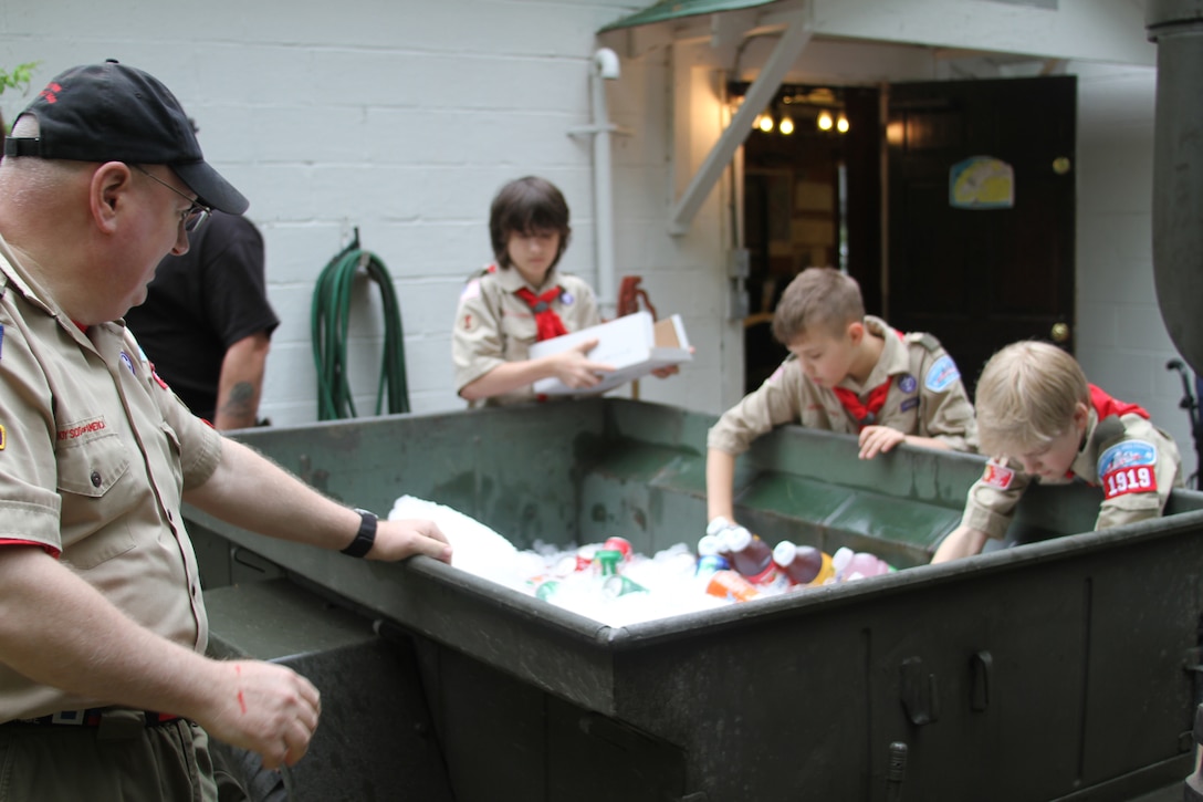 Bill Fortner, assistant scoutmaster, Boy Scout Troop 1919, oversees his scouts as they put beverages on ice for the Quantico Rod and Gun Club’s annual Wounded Veteran Picnic at Lunga Park, May 14. Scouts from the Dale City, Va. troop helped set up and serve food to veterans in attendance.