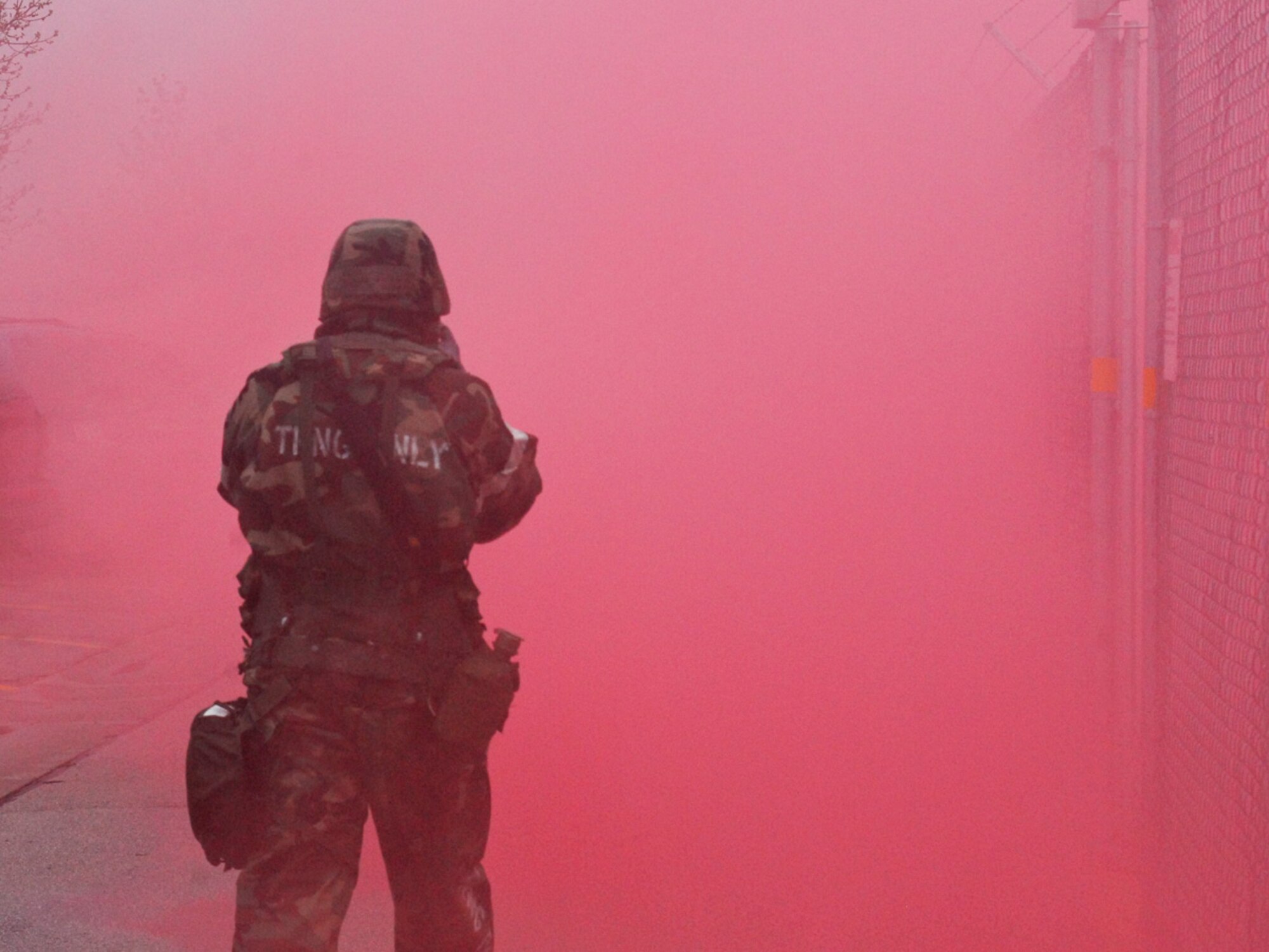 An Airman assigned to the 128th Air Refueling Wing, Milwaukee, navigates through the obscuring smoke of a simulated chemical attack during an Ability to Survive and Operate exercise at Gen. Mitchell International Airport on Saturday, May 14, 2011. The ATSO exercise tested the readiness and preparedness of Airmen to survive and operate during chemical, nuclear, and biological attacks.