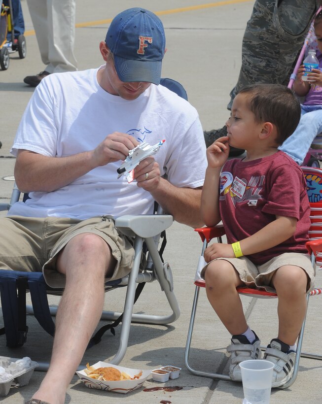 Gary Neal plays with his son Landon Neal during the Air Power over Hampton Roads Open House at Langley Air Force Base, Va., May 13, 2011. The open house provides a venue in which the public can see modern and historical military aircraft in action. (U.S. Air Force photo by Senior Airman Antoinette Gibson)(RELEASED)