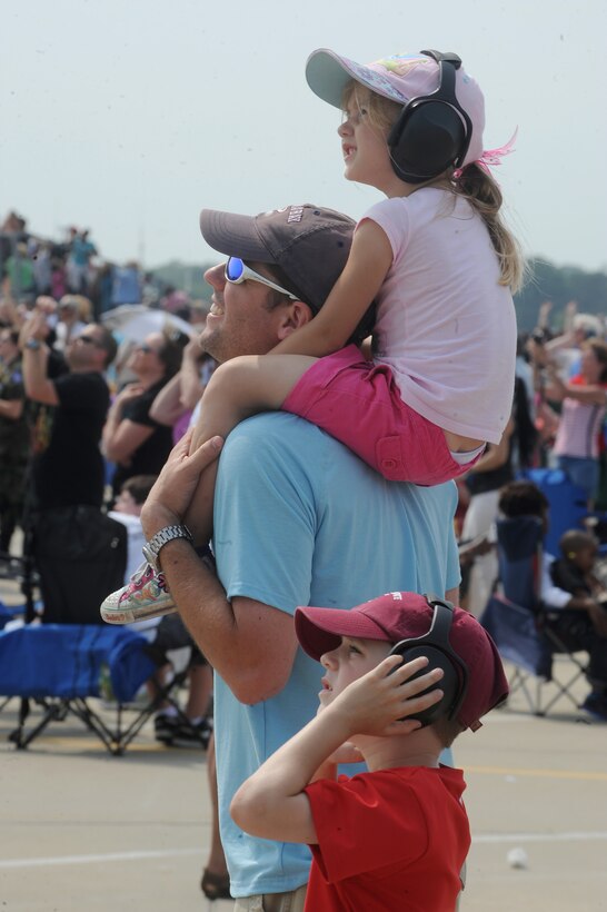 Jason Orrock and his two children Audrey and Evan watch the Thunderbirds’ demonstration during the Air Power over Hampton Roads Open House at Langley Air Force Base, Va., May 13, 2011. The open house educates the public on past and present Air Force aerial capabilities, and increases recruiting. (U.S. Air Force photo by Senior Airman Antoinette Gibson)(RELEASED)